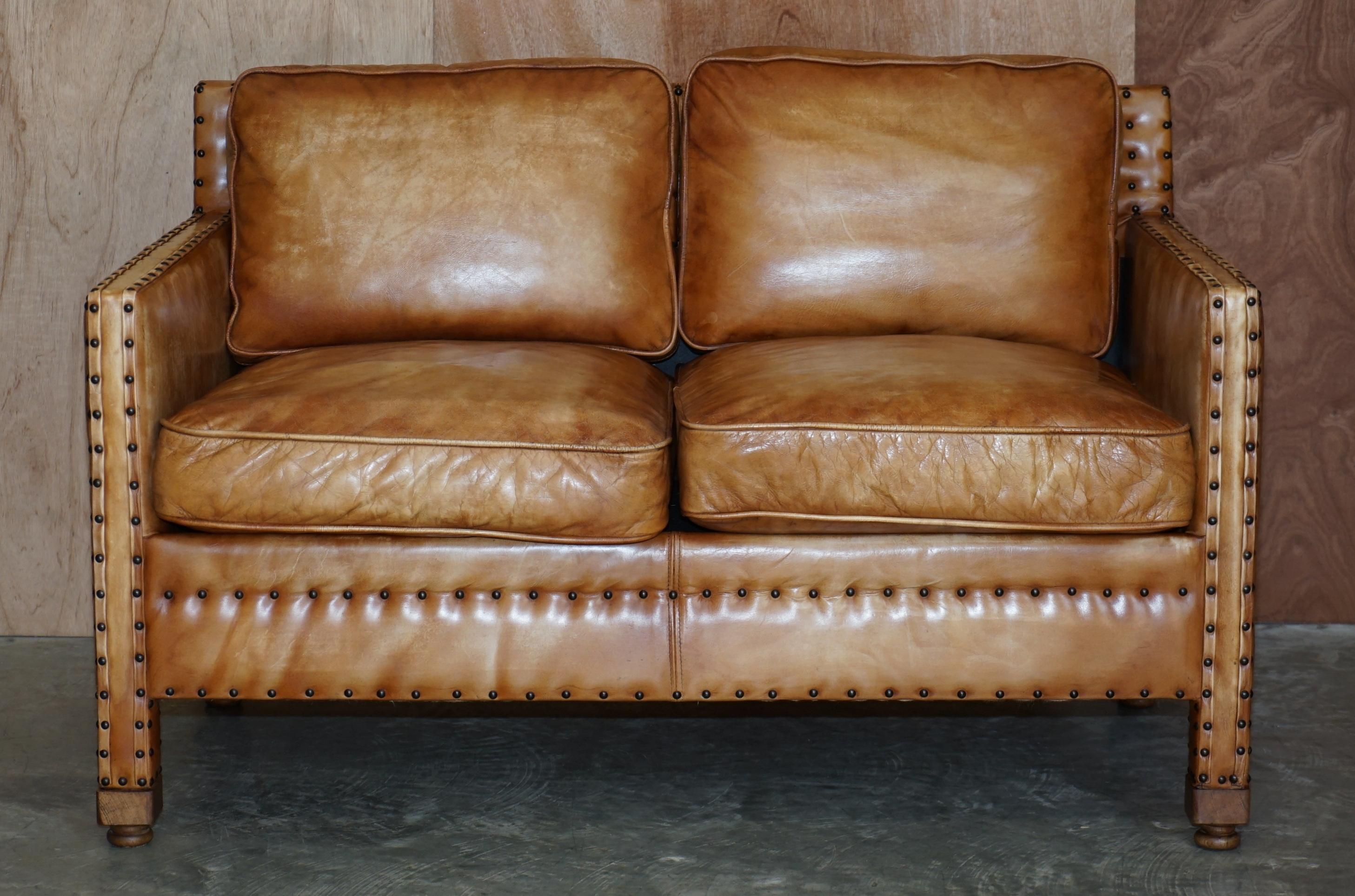 We are delighted to offer this lovely hand dyed tan brown leather two seat sofa with ornate stud work all over

The sofa is well made and stylish, the leather is fully aniline cattle hide so it has a thick natural look, its then hand dyed and