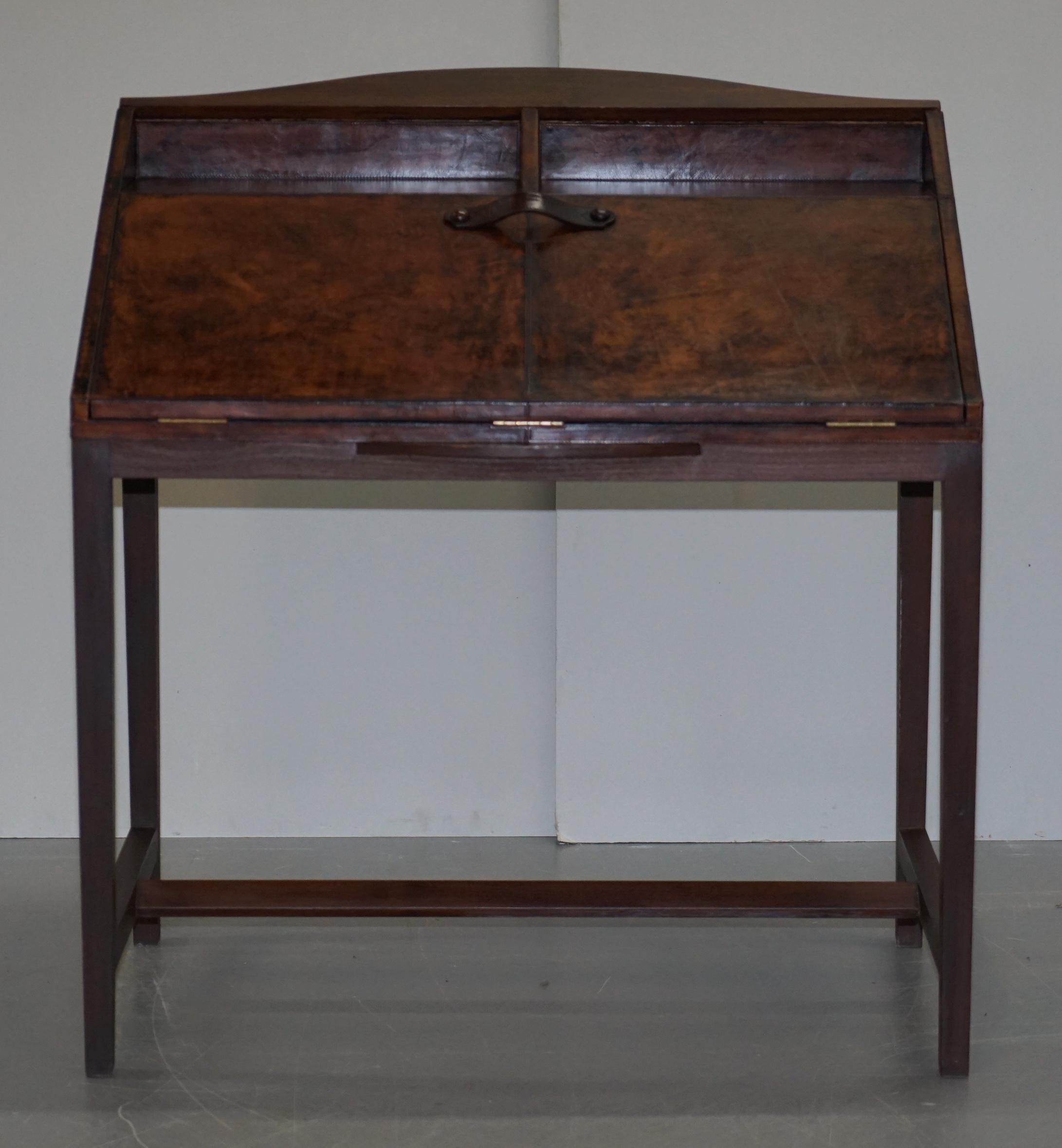 We are delighted to this lovely brown leather upholstered writing bureau desk with drop front and twin drawers inside

A good looking and well-made desk, I can’t see a sign of use on it anywhere, it looks new

We have cleaned waxed and polished