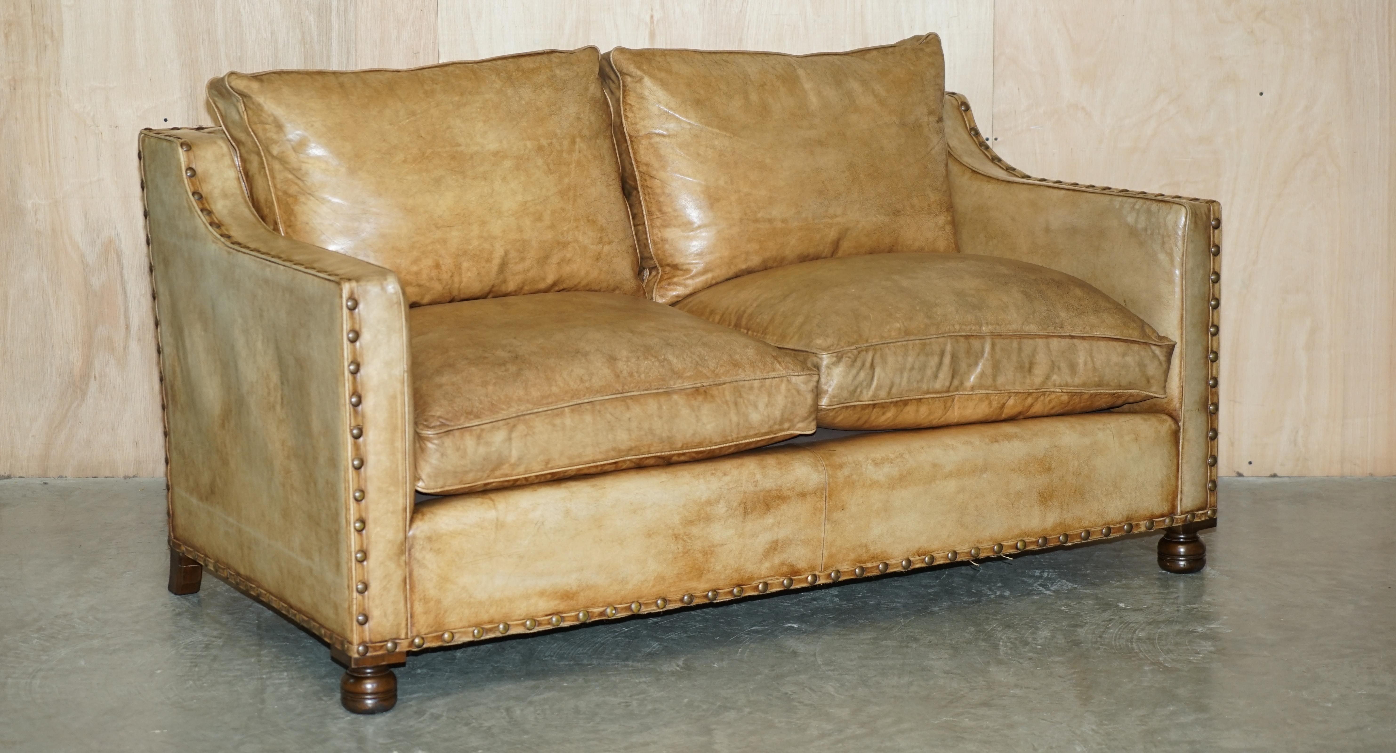 We are delighted to offer for sale this lovely hand dyed tan brown leather two seat sofa with ornate stud work all over.

The sofa is well made and stylish, the leather is fully aniline cattle hide so it has a thick natural look, its then hand