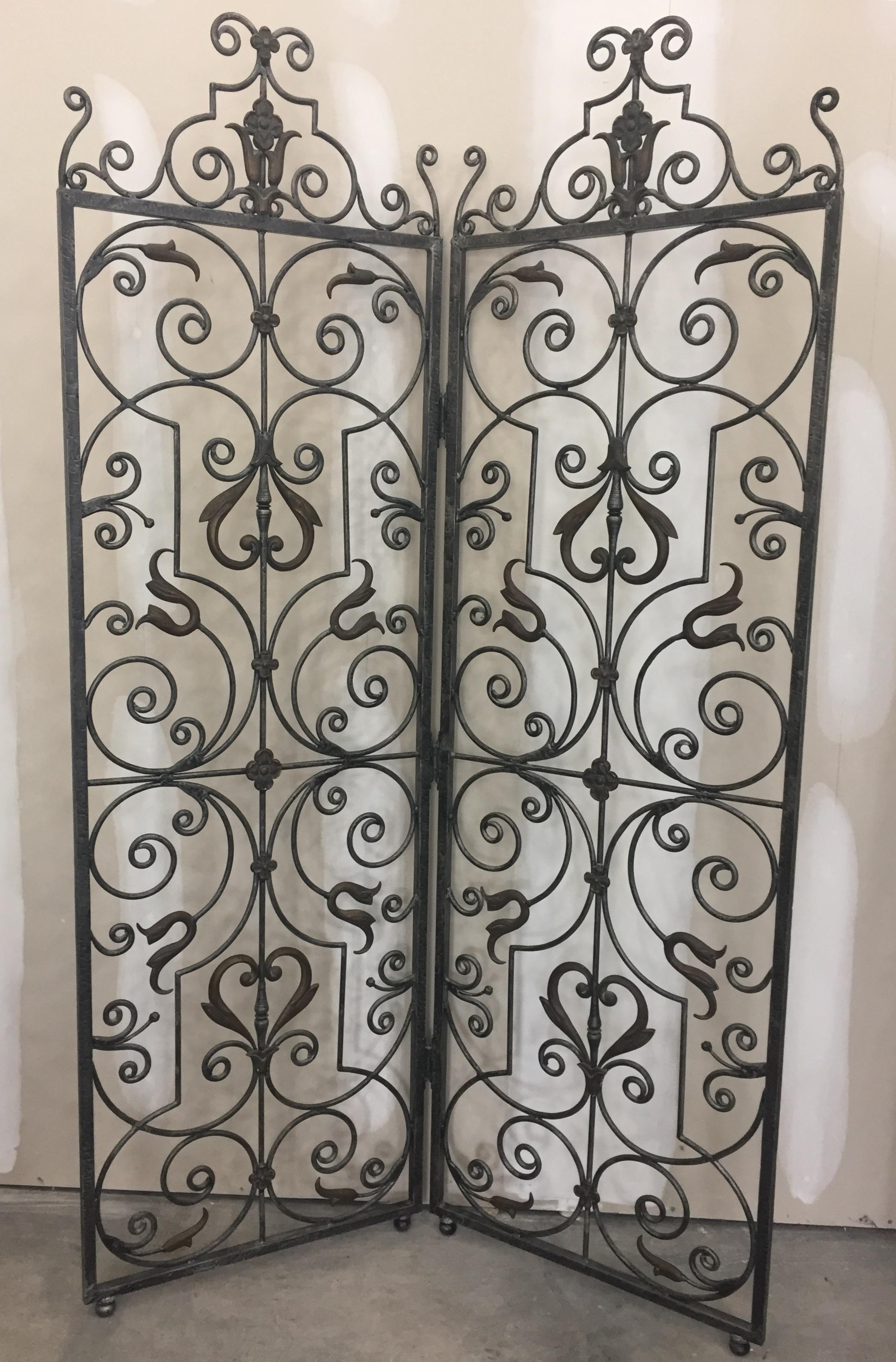 A wonderful hand forged gun metal colored wrought iron screen or room divider that adds an unexpected airy textural element to a space. 

Each panel is 24 W.