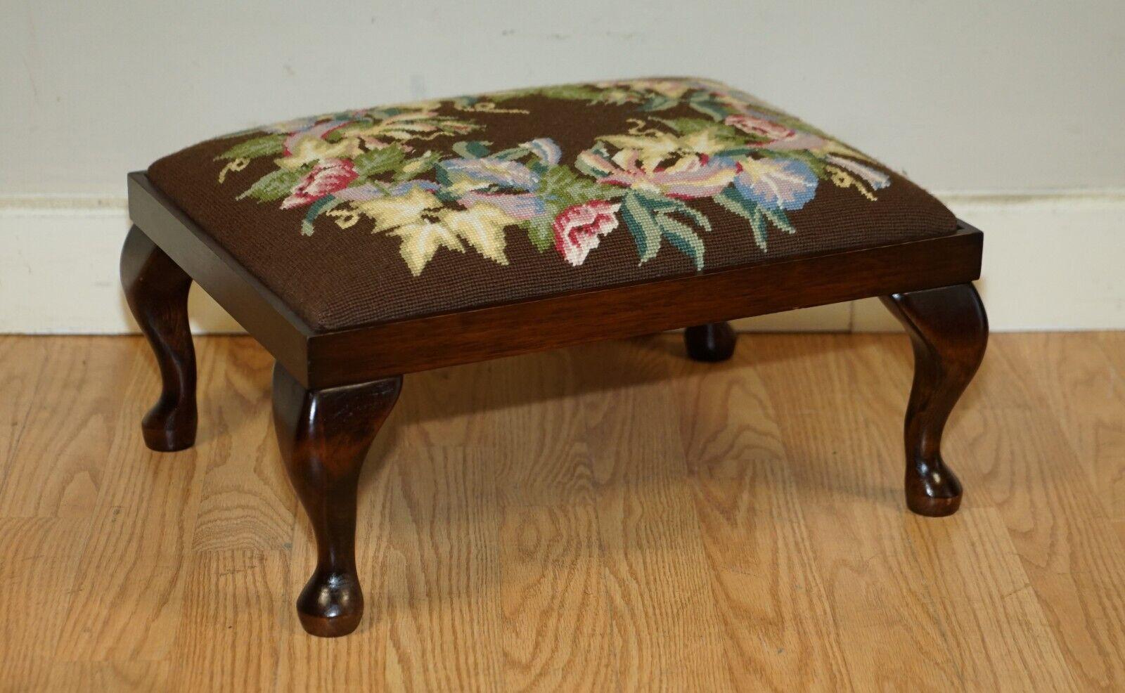 Here we have for sale this lovely mahogany and embroidered floral vintage footstool stool. This footstool is the perfect size for sliding under a wingback armchair. As you can see from the pictures it is in fantastic condition, it has been waxed and