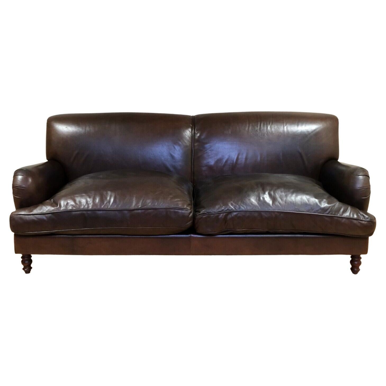 We are delighted to offer for sale this elegant Vintage Howard style brown leather three seater sofa with reversible cushions.

This elegant and well made sofa is comes with a generous seating area, giving its comfortable feel for three people. This
