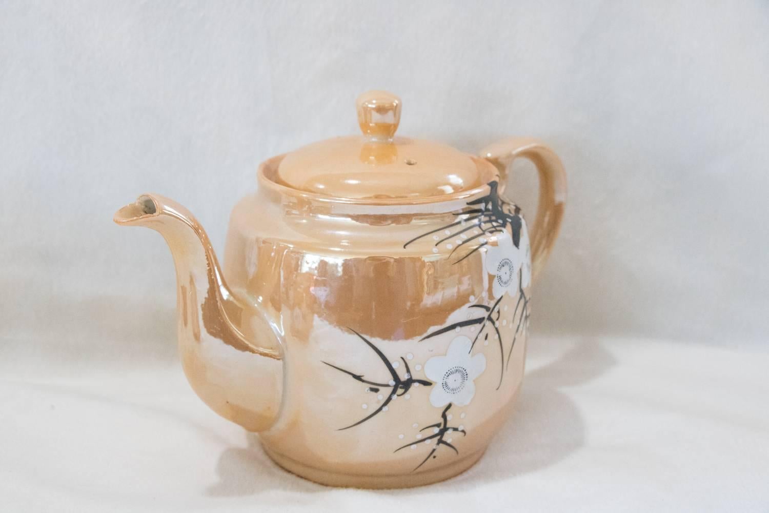 All that glimmers is not gold! Hand-painted Japanese coffee/tea white cherry blossom design iridescent interior. Beautiful soft porcelain in an iridescent taupe - coffee/tea pot, creamer, sugar, four cups, two saucer plates.

Measure: Sugar bowl:
