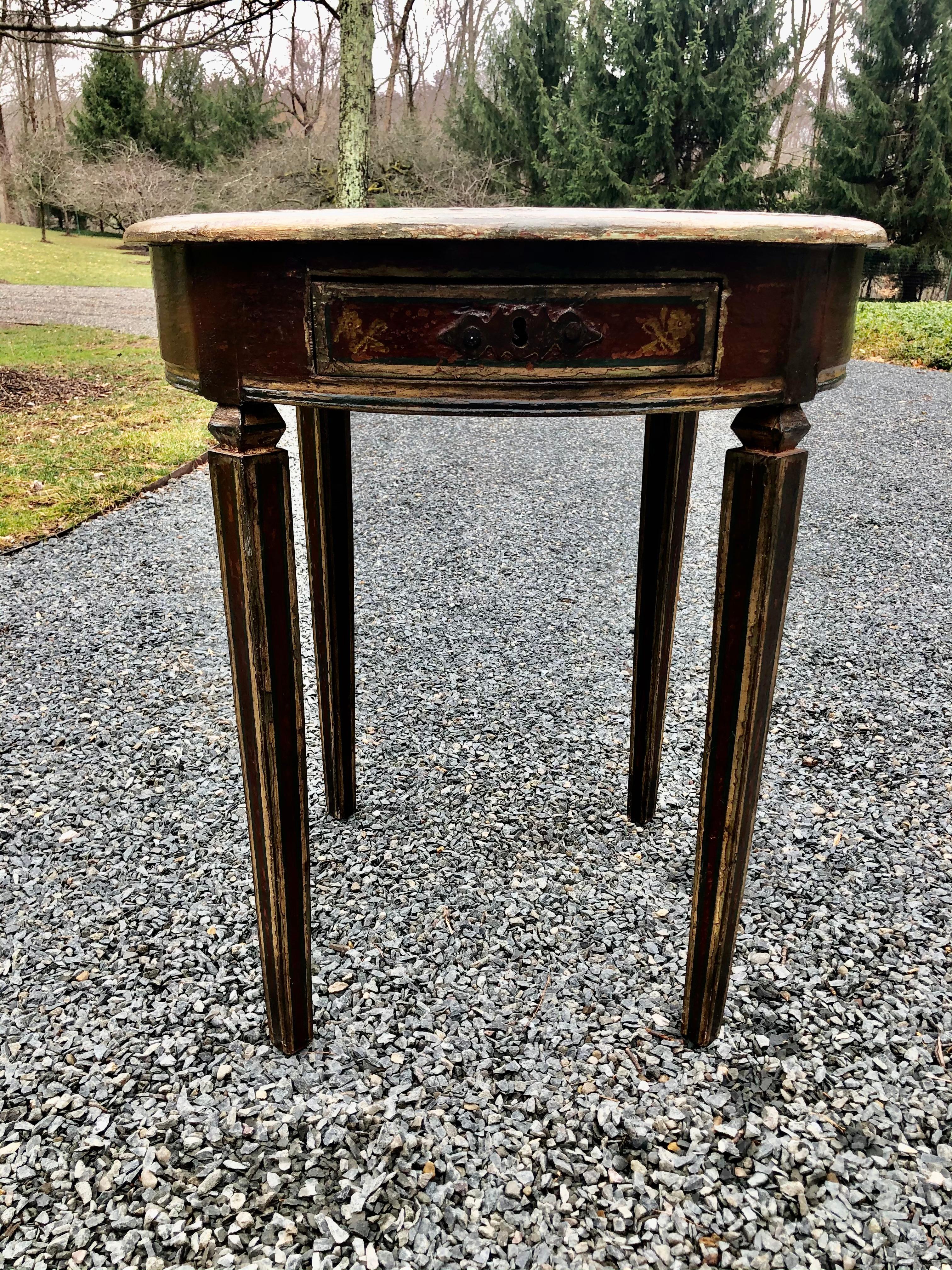 Charming vintage Italian country style side table hand painted and distresed with a floral and vine motif in an ochre colored paint. The hand painting continues around the entire table; the legs have painted decoration as well.