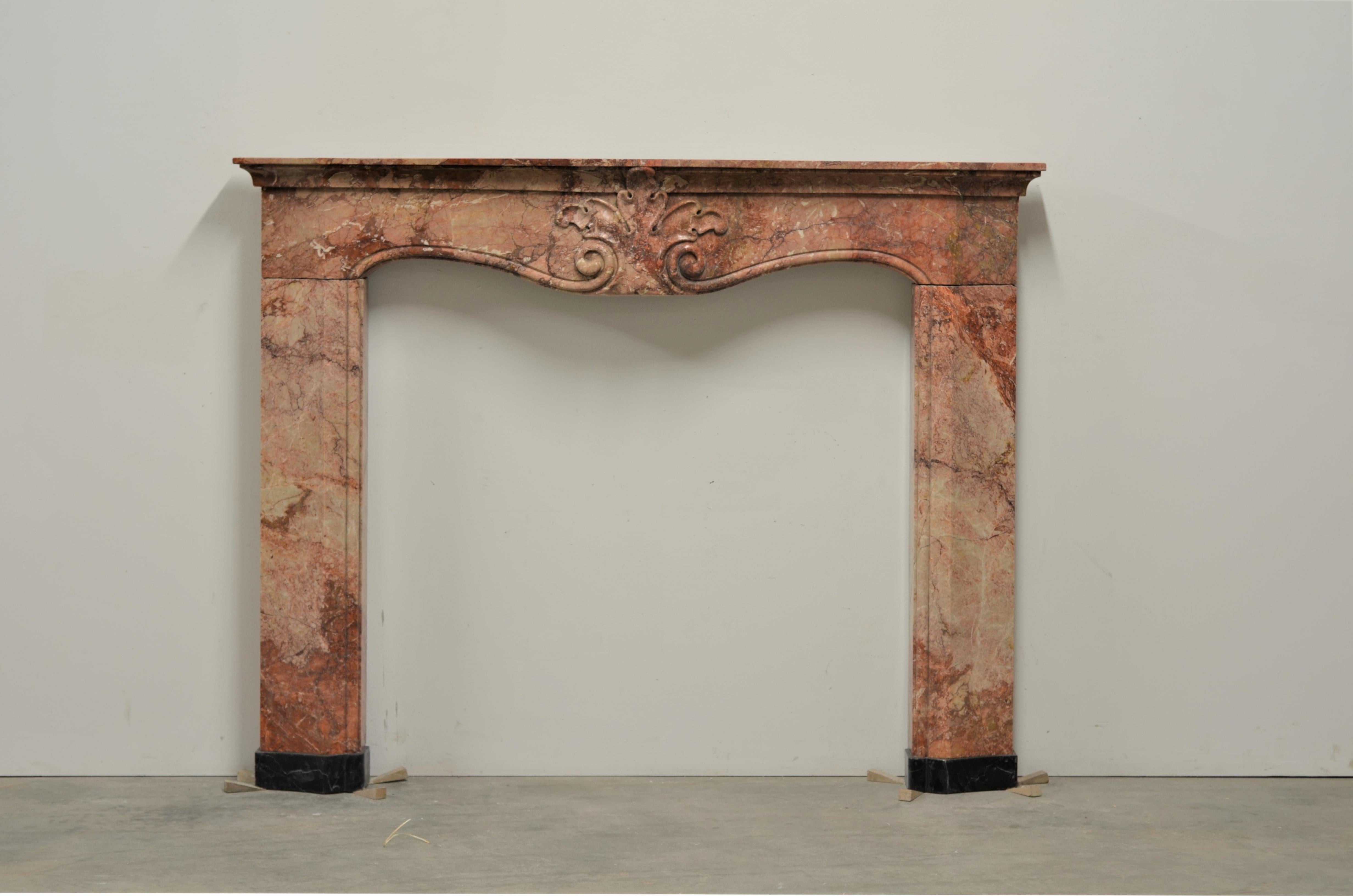 Very nice and colorful fireplace mantel from the Northern part of Italy.
This Italian beauty dated from the beginning of the 19th century it was reclaimed from a large estate.
Its vivid marble, strong shapes and lovely central shell make this a