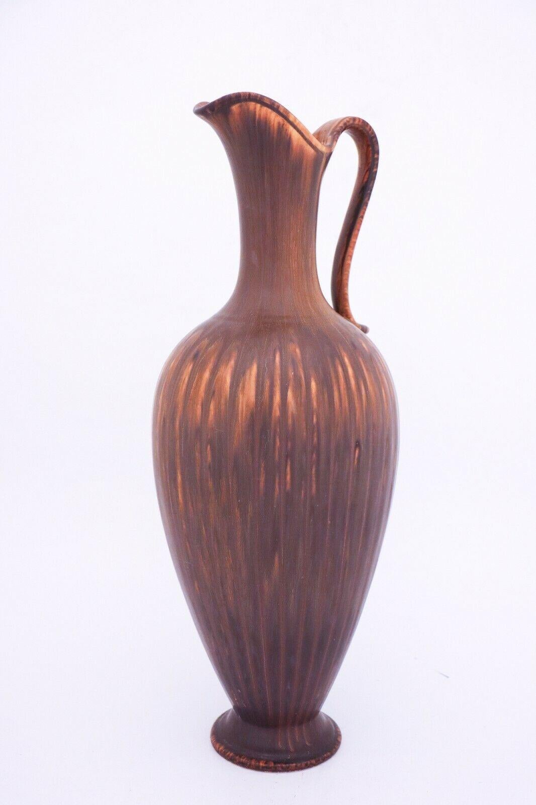 A lovely brown vase designed by Gunnar Nylund at Rörstrand. It is 45 cm high and in very good condition except from some minor scratches. The vase is marked as 1st quality. 

 