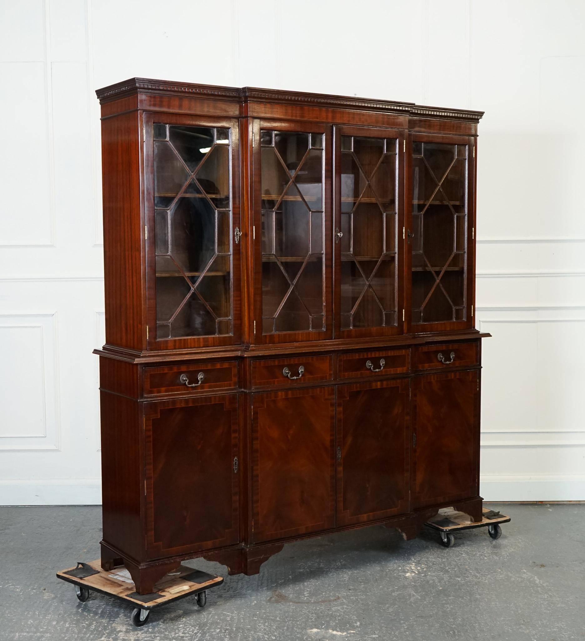 
We are delighted to offer for sale this Large English four-door breakfast bookcase.

A lovely large English four-door Georgian-style breakfront bookcase is a stunning piece of furniture that embodies the elegance and grandeur of traditional