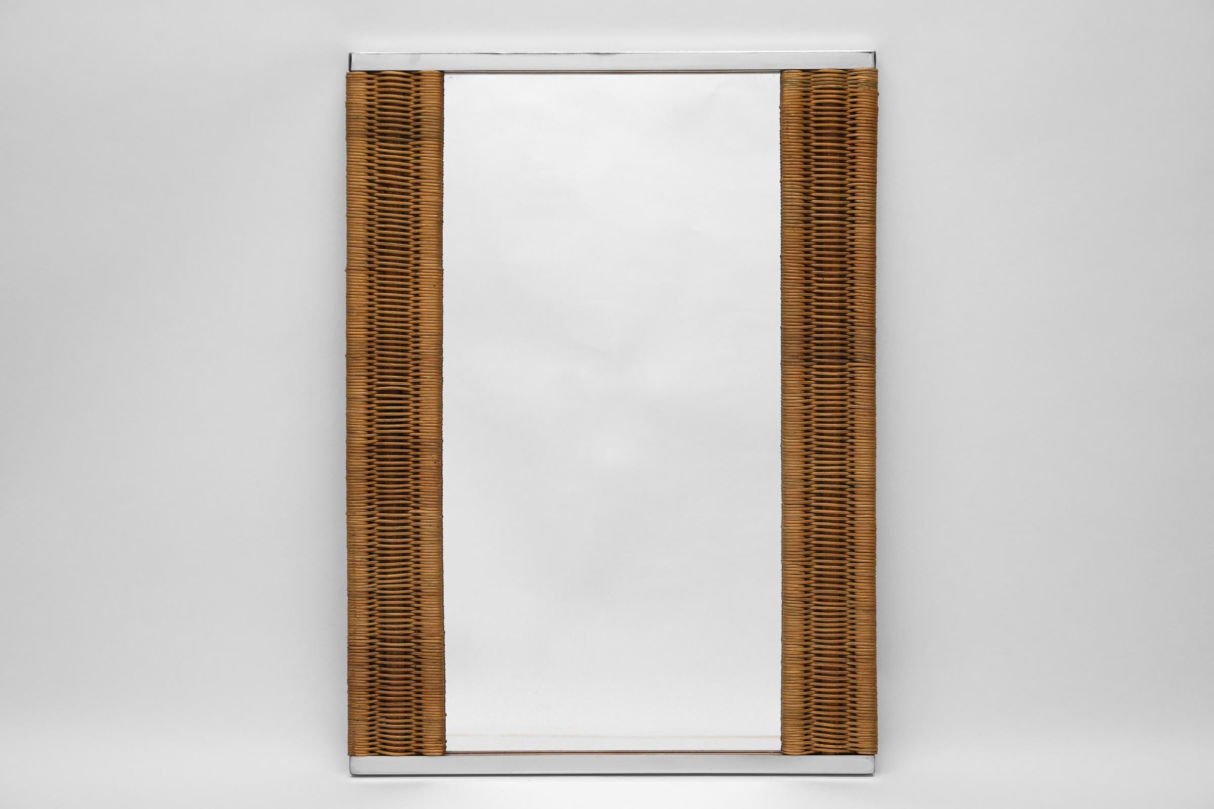 Very beautiful rectangular wall mirror made of 4-sided chrome frame with rattan weave. In the style of Gabriella Crespi.