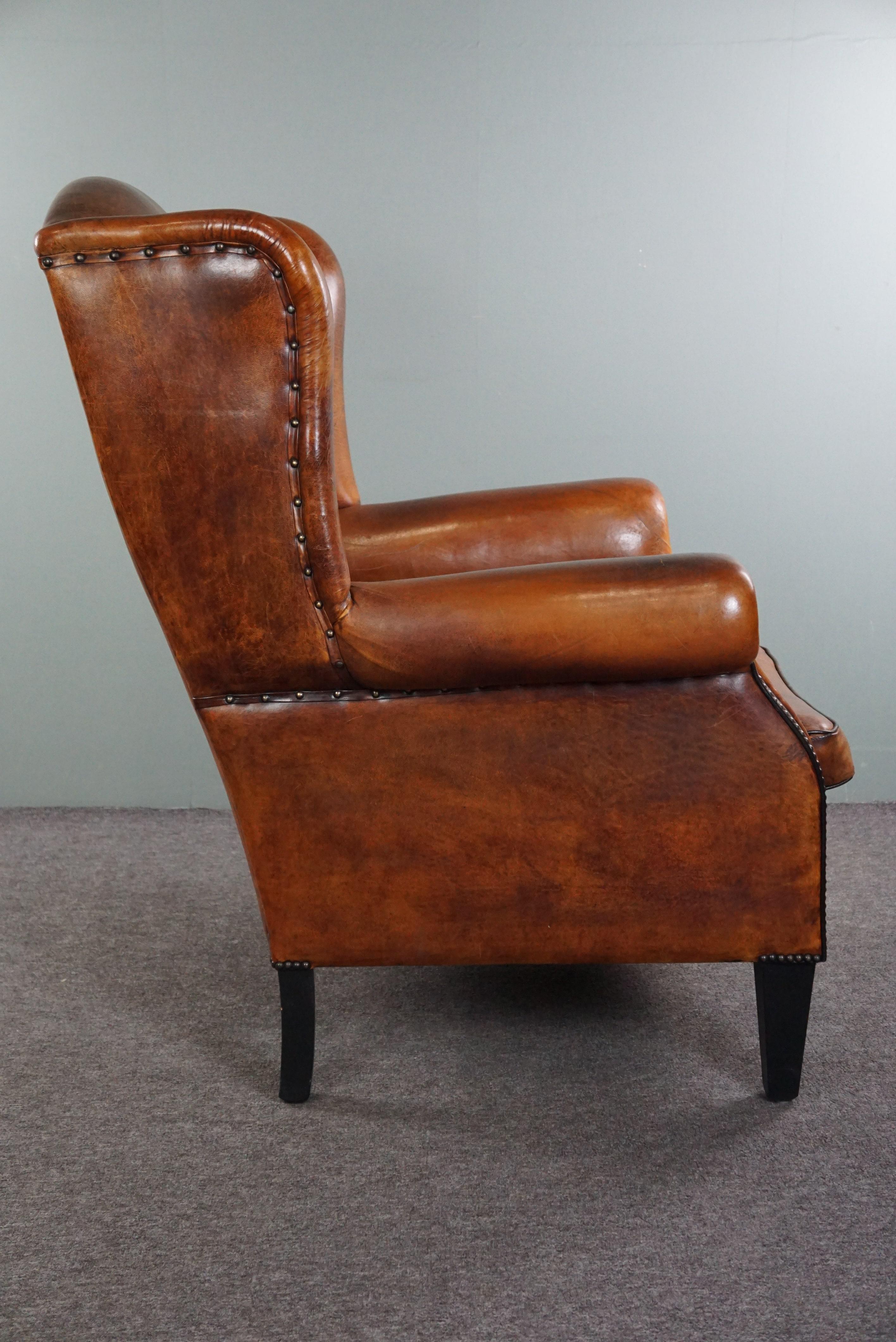 Classical Roman Lovely large sheepskin leather wingback armchair with very good seating comfort For Sale