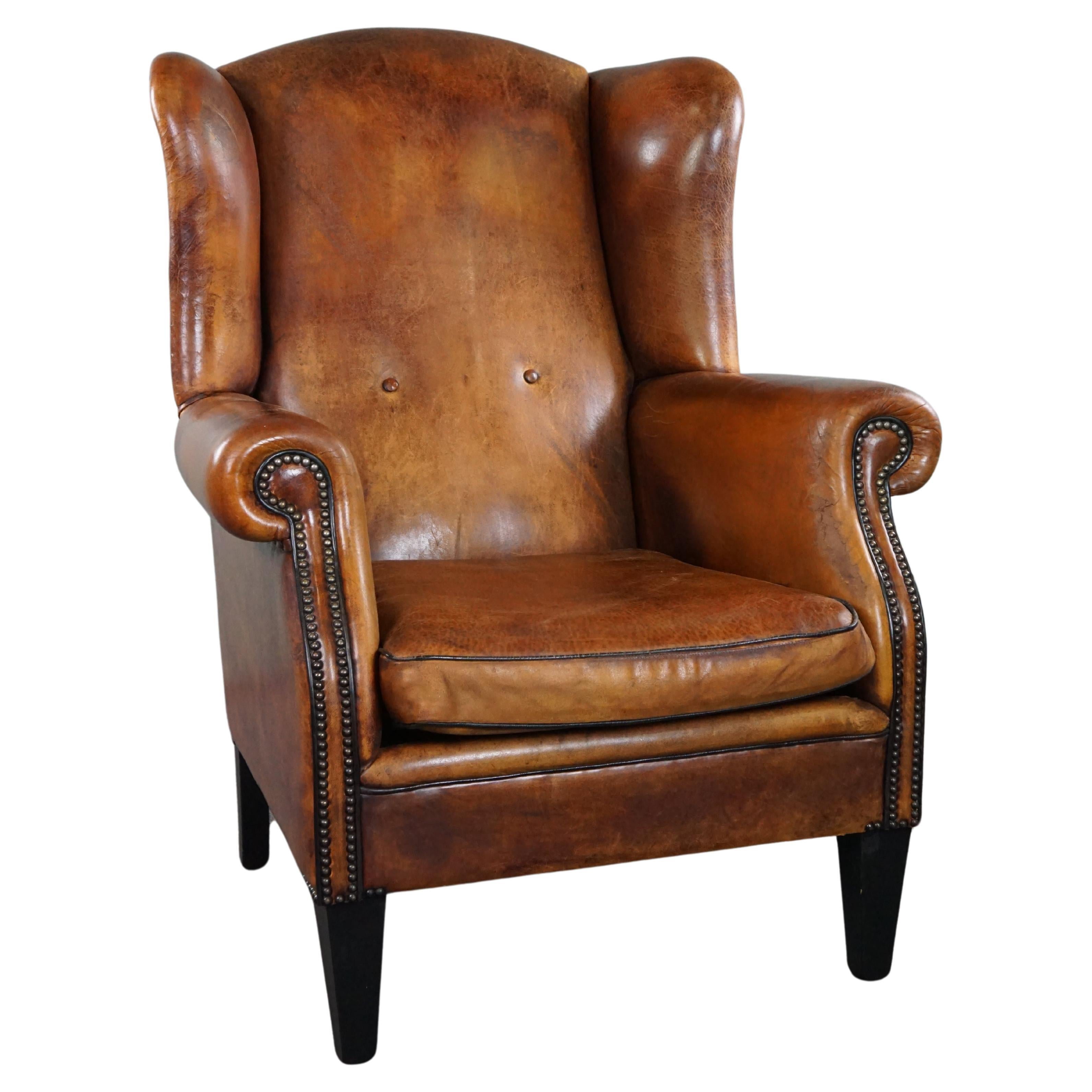 Lovely large sheepskin leather wingback armchair with very good seating comfort For Sale
