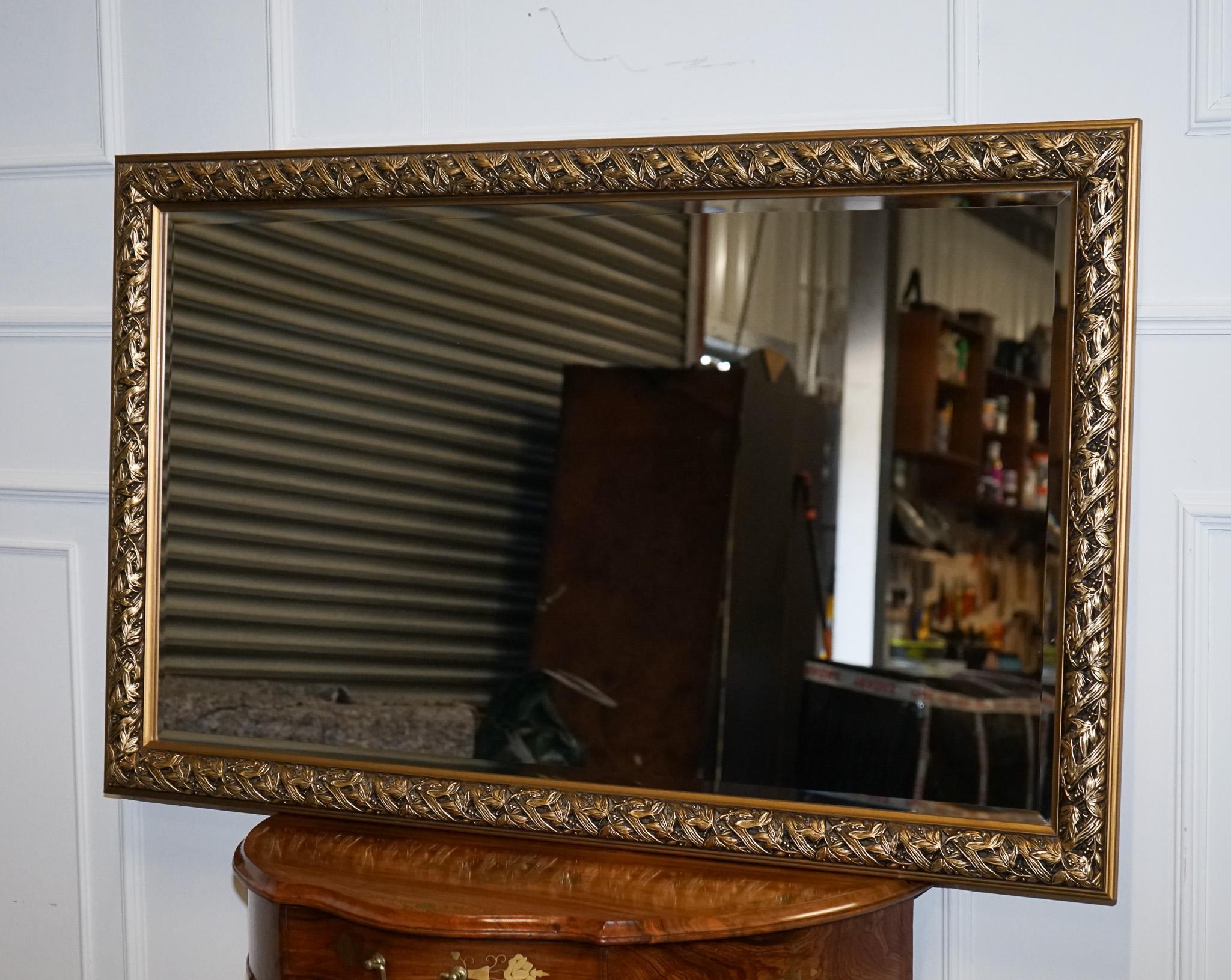 
We are delighted to offer for sale this Lovely Large Gold Ornate Bevelled Wall Mirror.

A Vintage Gold Ornate Bevelled Wall Mirror is a beautifully crafted and elegant piece of decor that adds a touch of vintage glamour to any room. This particular