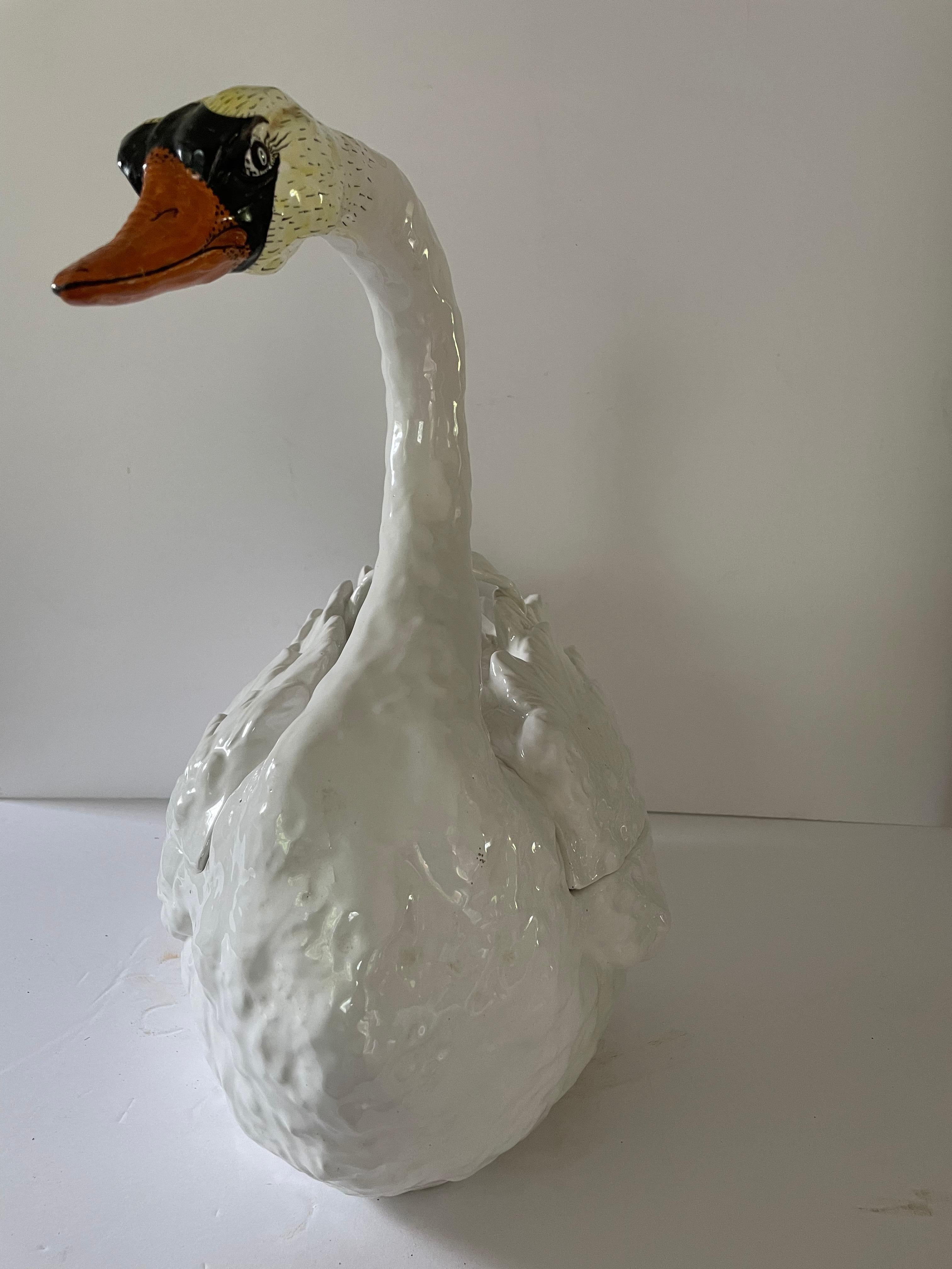 Lovely and large vintage ceramic swan tureen or cachepot having handpainted face and feet with marvelous feathered back which is removeable for a plant or to use as a serving piece. Marked Italy.