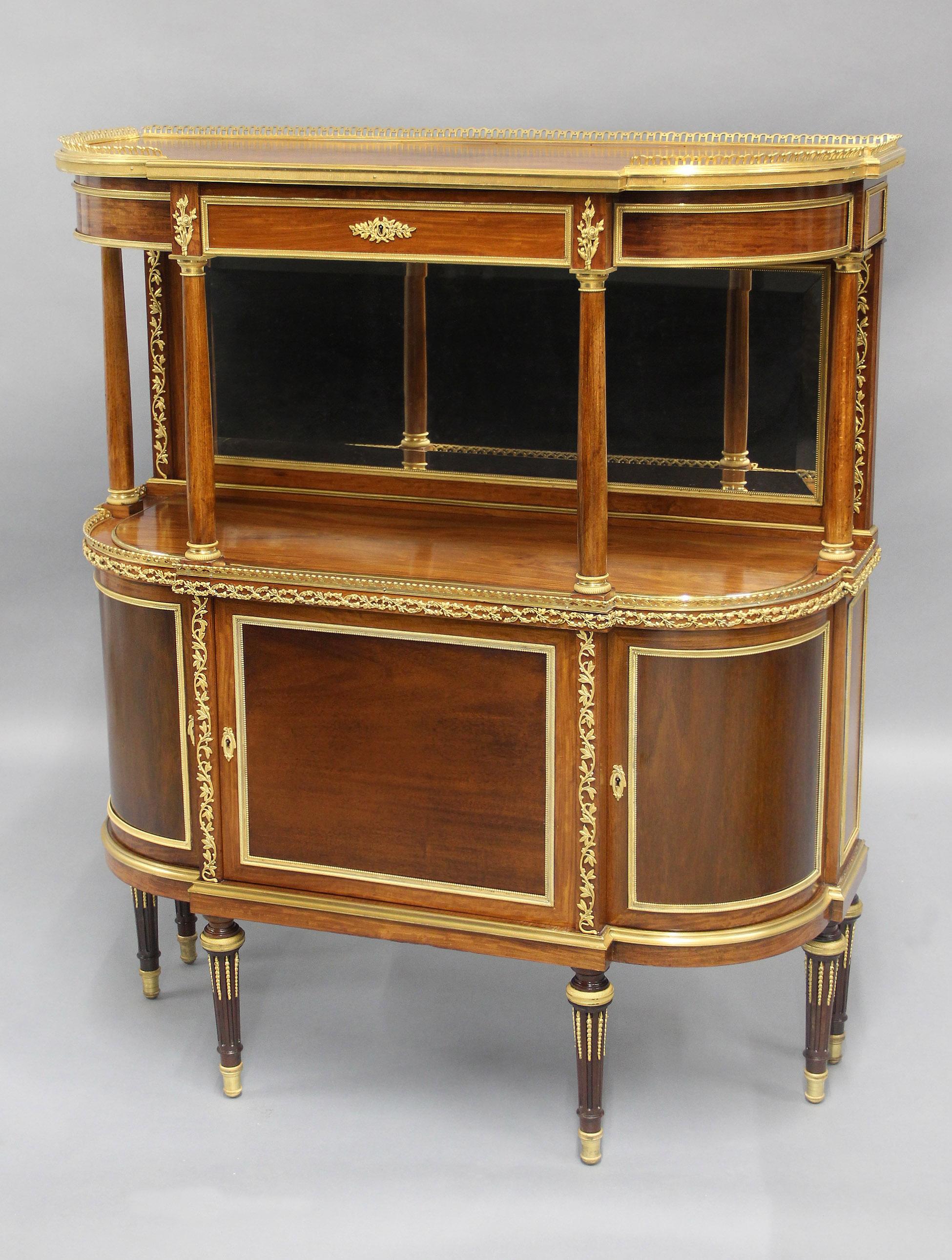 A Lovely Late 19th Century Gilt Bronze Mounted English Cabinet / Server By Hampton & Sons

By Hampton & Sons

A reticulated bronze gallery above a single drawer, the upper structure with a bevel mirrored back and four columns, over a centered and