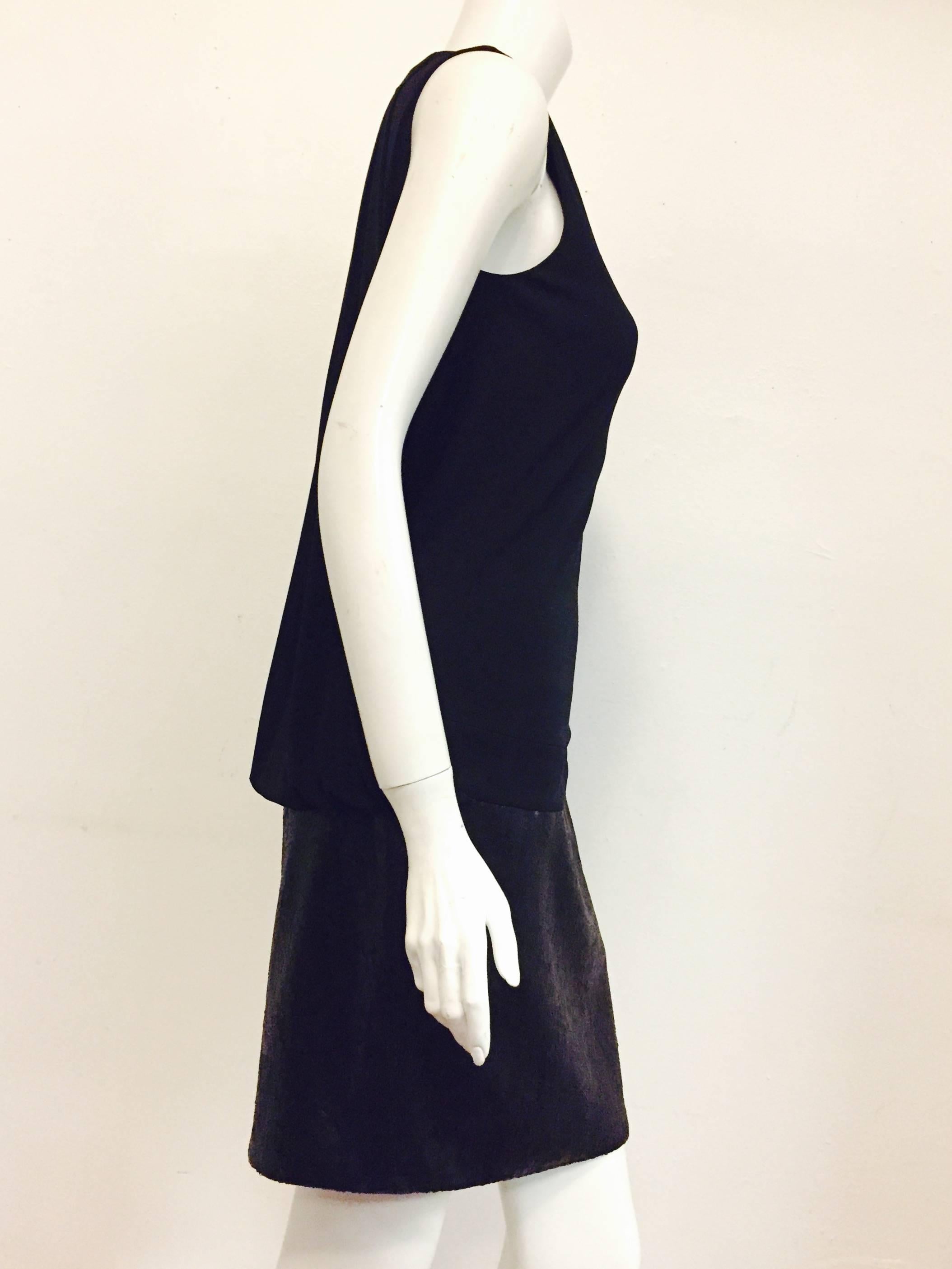 A Beguiling Baday black dress with matte sequined skirt and viscose top is sure to please all admirers!  This sleeveless dress has a dropped waist, gathered and draped back.  Tie at neck is the finishing touch!  Easy to wear and perfect for