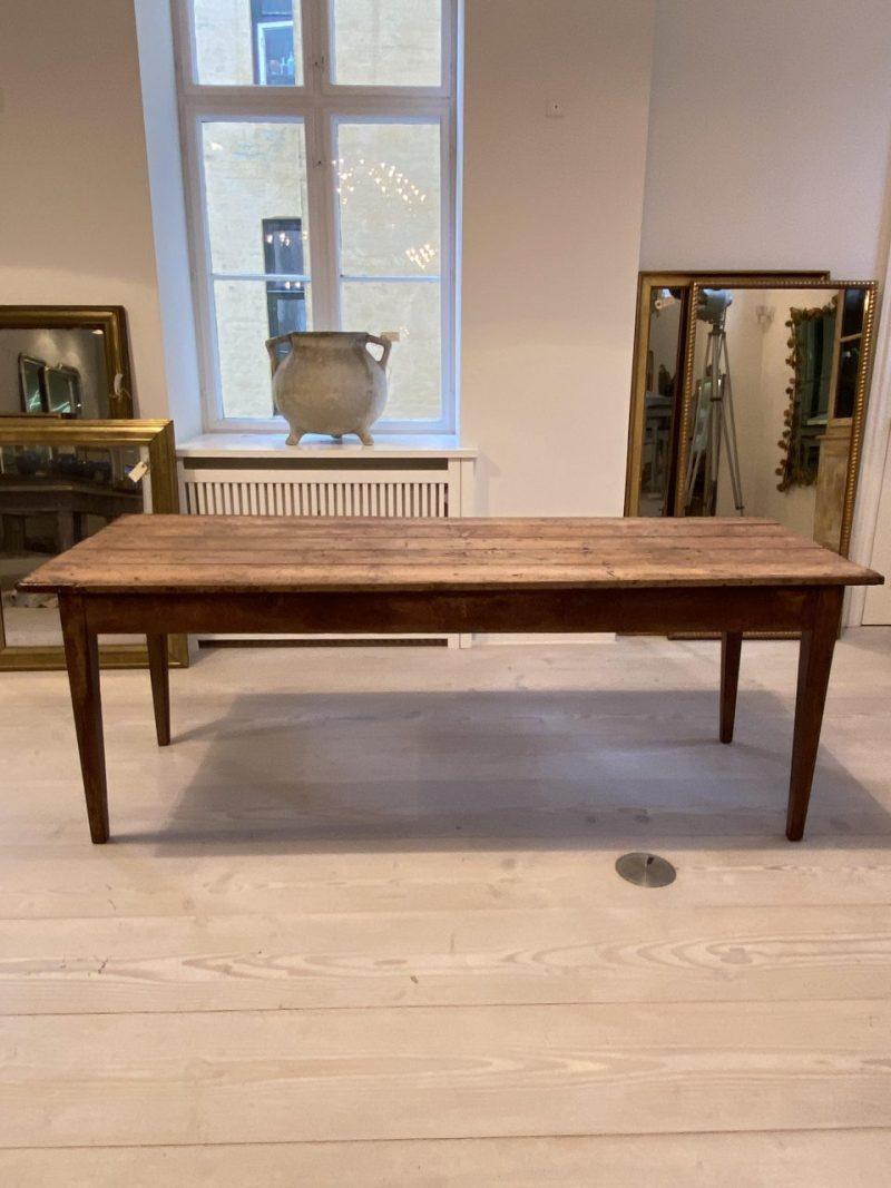 Handsome rustic antique French long table, made  in circa 1890-1900, in a wonderful simple design and with wide planks. Originally from an old French country house, where the servants ate their dinner together.

The table has a beautiful and much