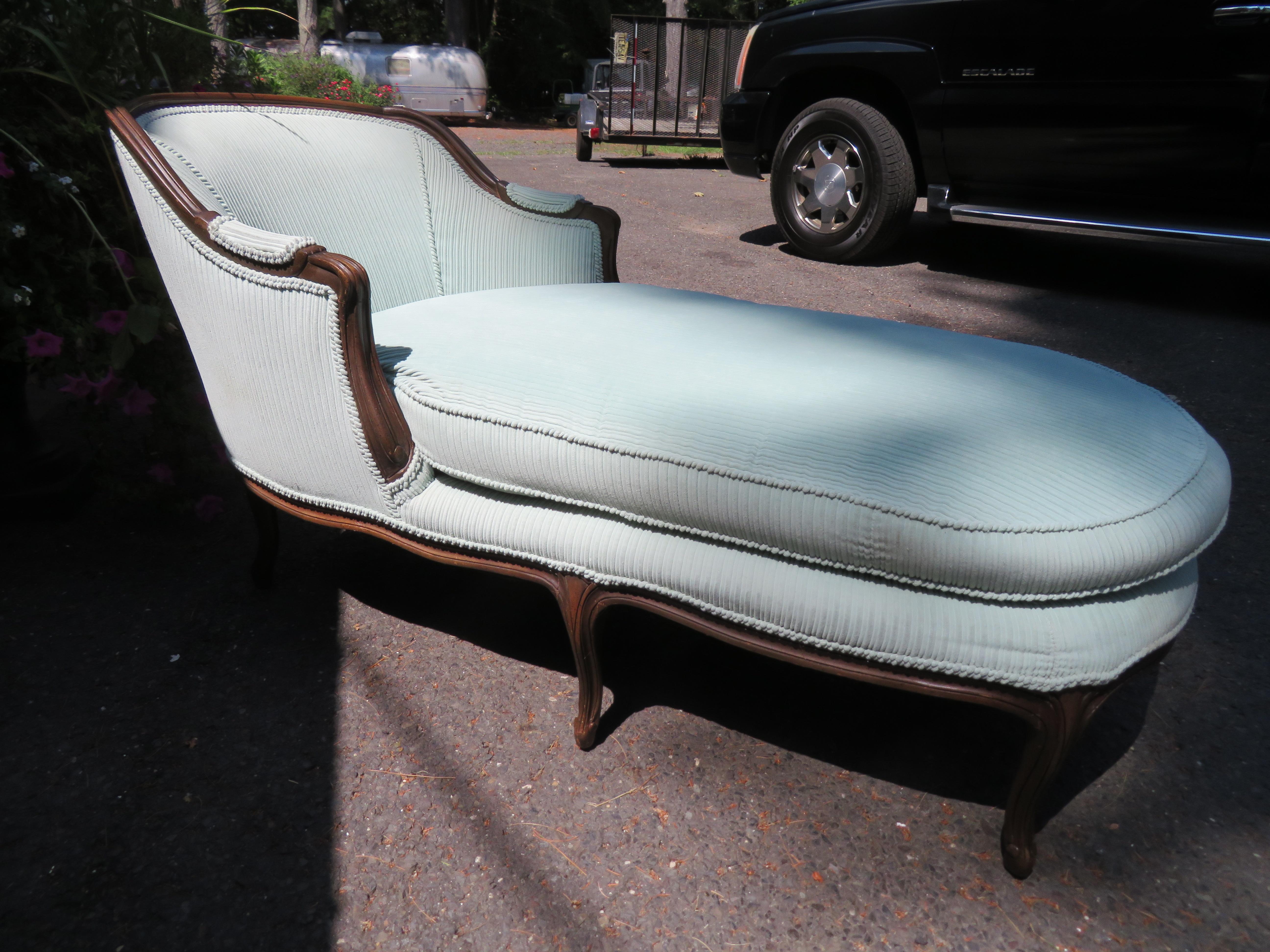 Lovely Louis XIV-style chaise lounge, circa 60's. This piece retains its original baby blue wide wale corduroy fabric in presentable condition-some light spots on one side of the double-sided cushion. The chaise lounge measures 31.5