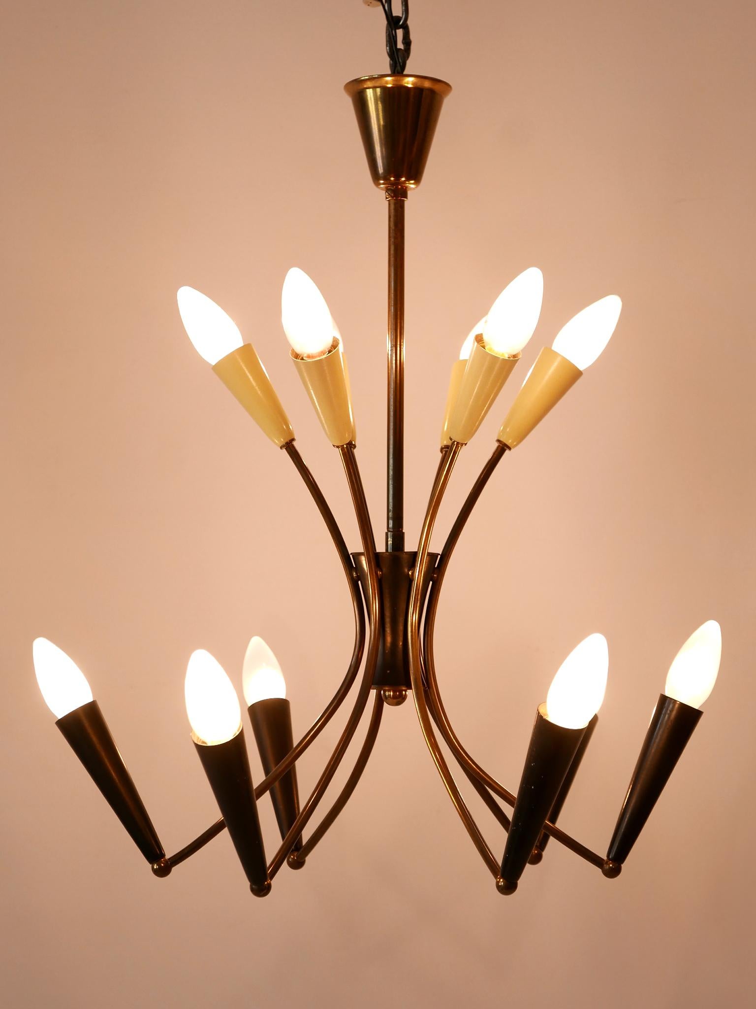 Lovely and highly decorative Mid-Century Modern 12-Flamed Sputnik pendant lamp or chandelier. Designed & manufactured in Germany, 1950s.

Executed in brass & metal, the pendant lamp / chandelier is executed with 12 x E14 / E12 Edison screw fit bulb