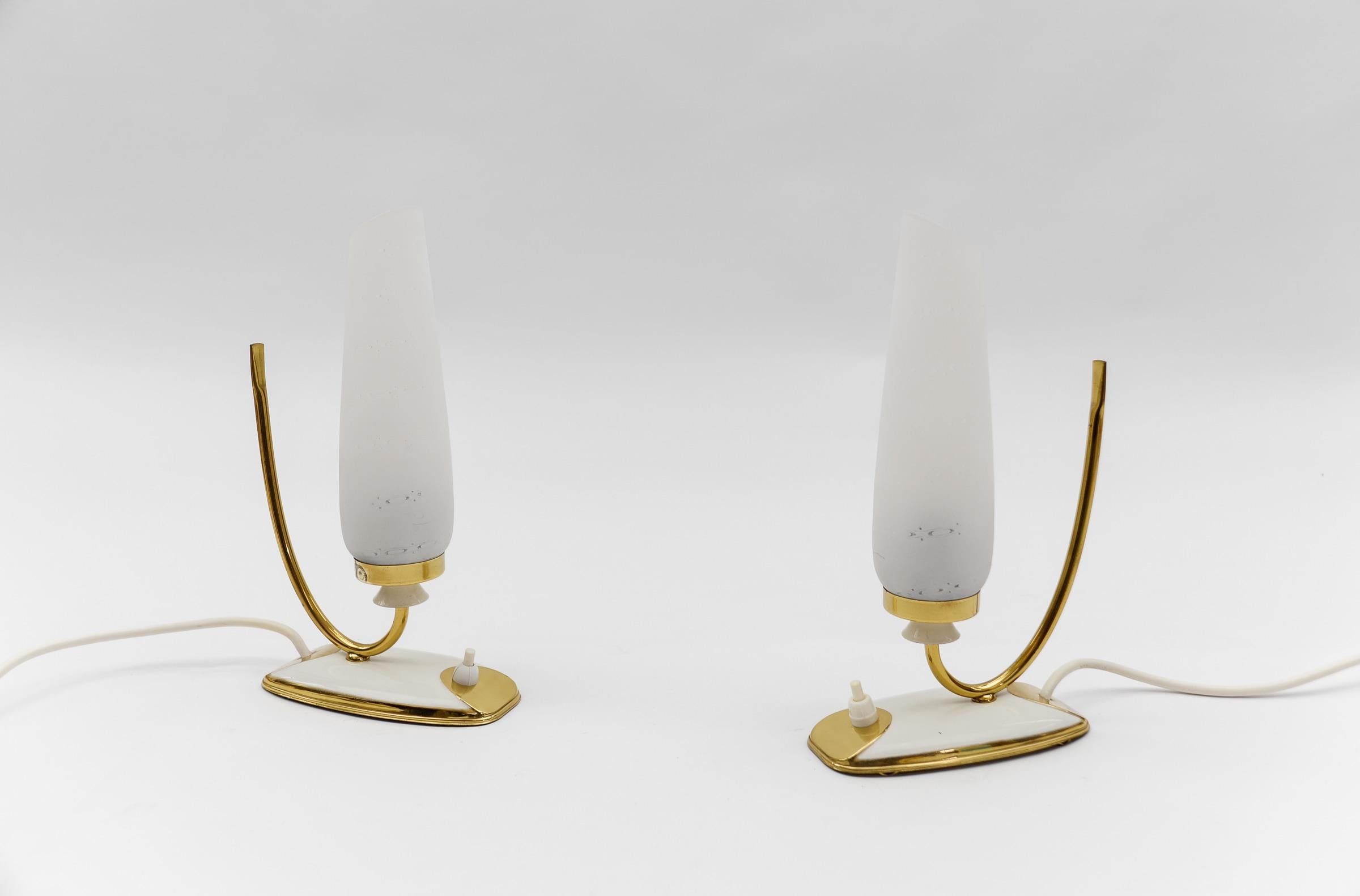 Lovely Mid-Century Modern Brass and Glass Table Lamps, 1950s  

Each lamp needs 1 x E14 Edison screw fit bulb, is wired, and in working condition. It runs both on 110 / 230 volt.

Very elegant and cute at the same time.

Light bulbs are not