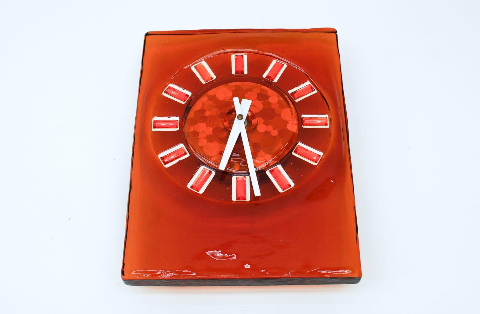 Stunning wall clock made of colored glass. 

An eye catcher par excellence.

Probably made in Italy.

Electric, battery operated clock.