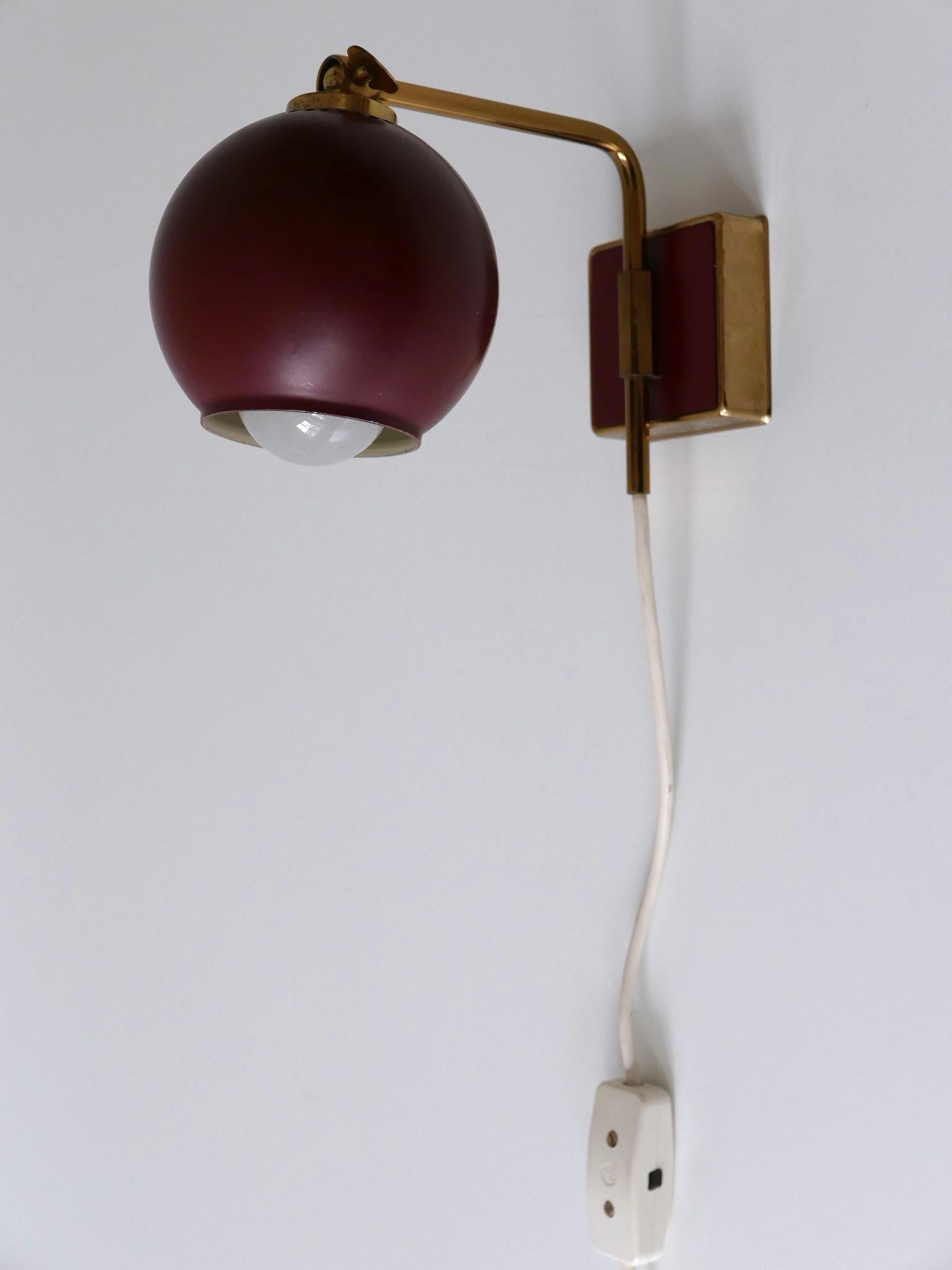 Rare and highly decorative Mid-Century Modern wall lamp or sconce. Designed & manufactured by Paul Neuhaus Leuchten, Germany, 1950s.

Executed in brass and in Bordeaux color enameled metal, the wall lamp comes with 1 x E14 / E12 Edison screw fit