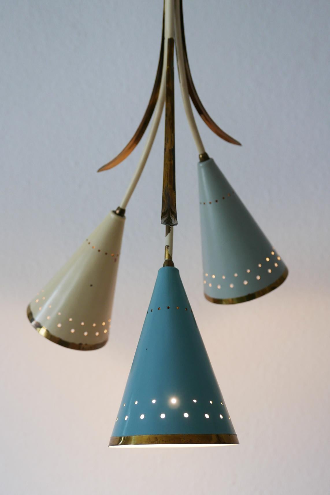 Exceptional Mid-Century Modern three-armed Sputnik chandelier or pendant lamp in lovely colors. Manufactured probably in 1950s in Germany.

Executed in brass sheet and tubes. The perforated brass lamp shades are in light green, blue and beige