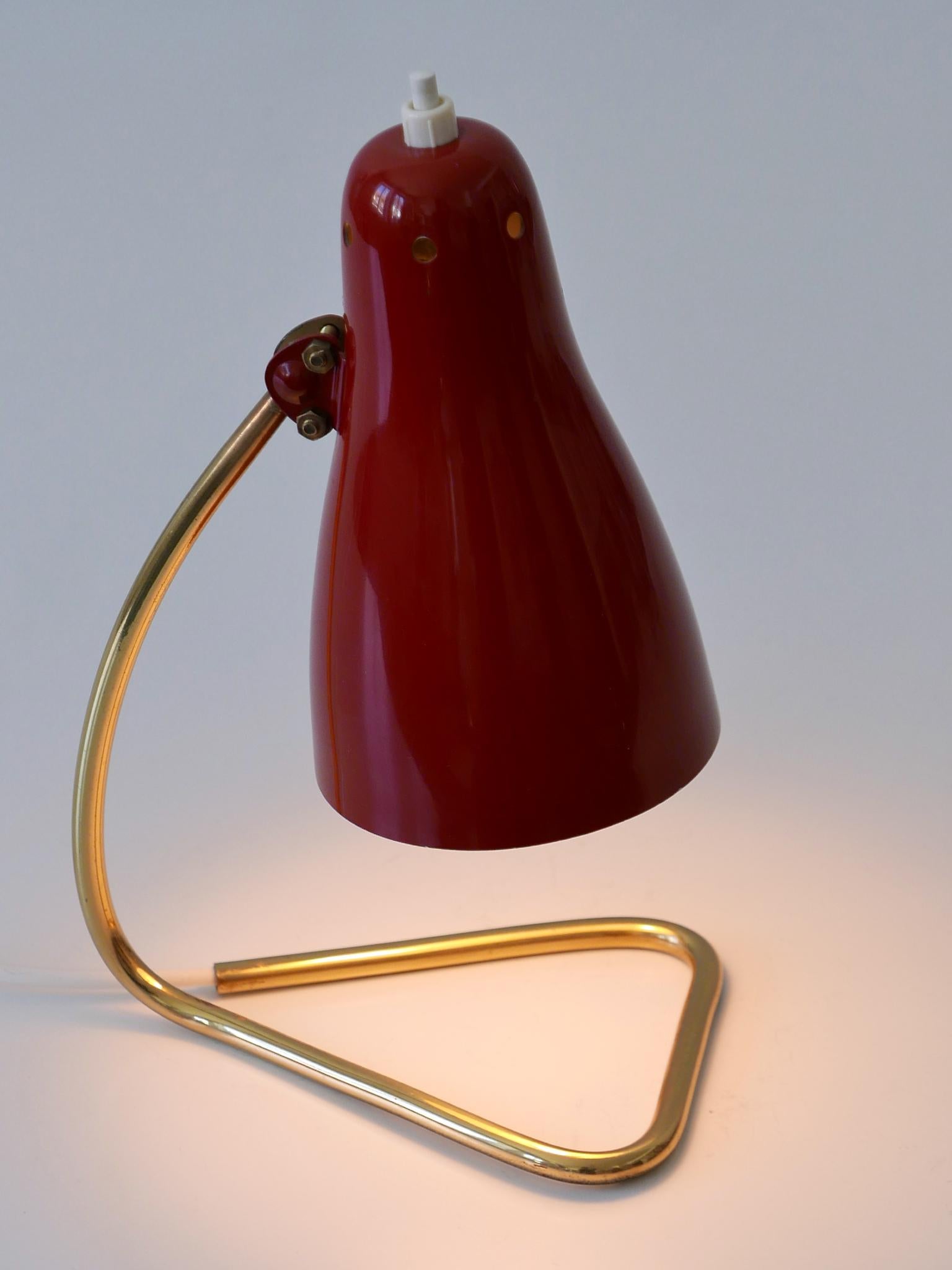 Lovely and highly decorative Mid-Century Modern table lamp or wall lamp. The lamp can be used both as a table lamp and as a wall light. Shade adjustable in various position due to the joint ball. Manufactured by Rupert Nikoll, Austria,