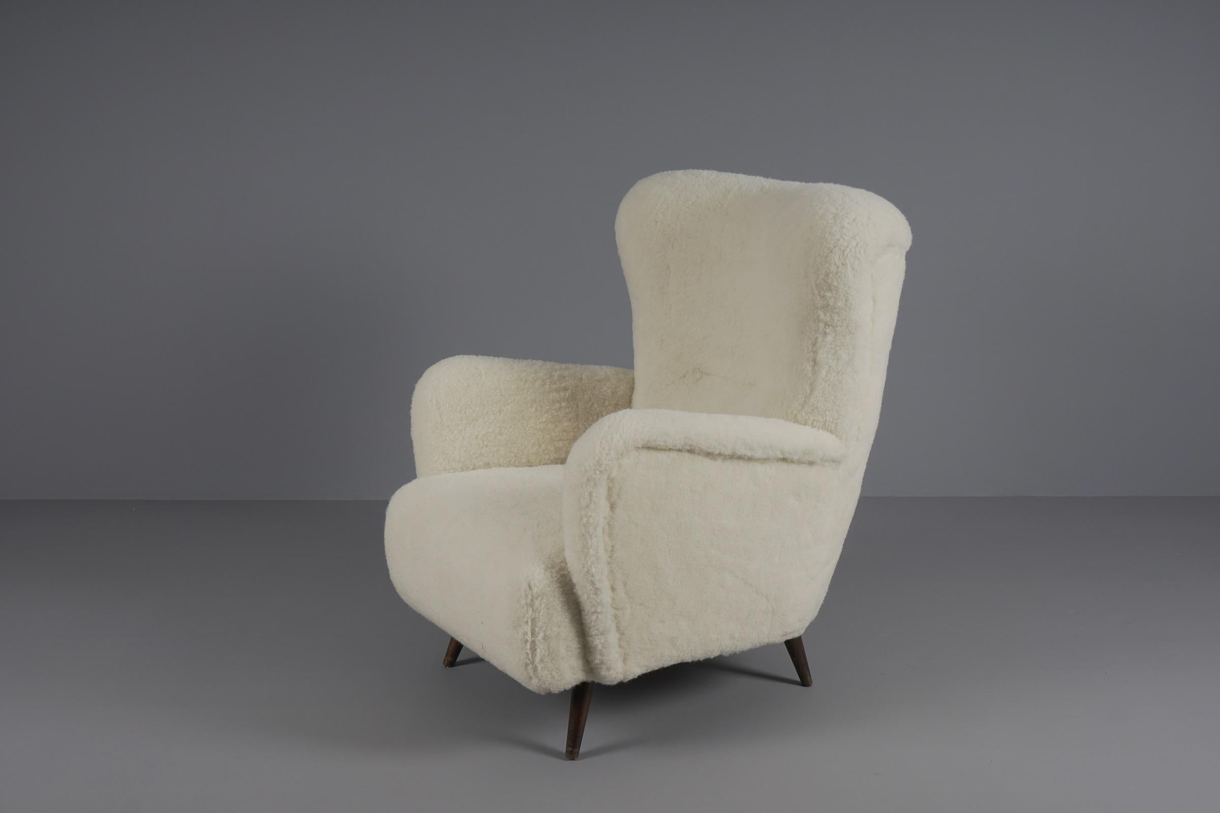 Large and shapely Scandinavian wingback chair.

Made of 100% genuine sheep's wool. 
 
Fits perfectly to the current cozy season but also otherwise to any naturally kept interior.