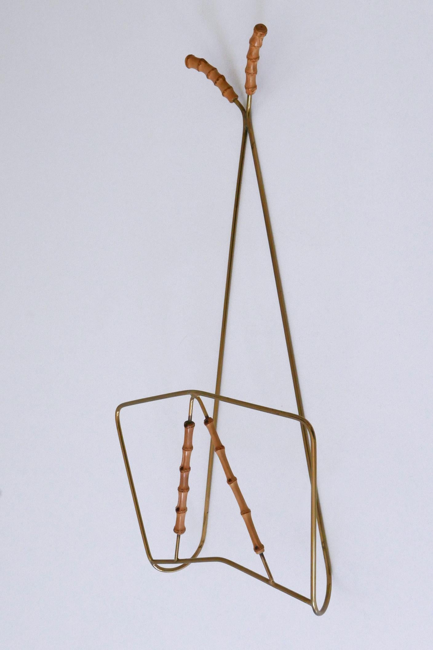 Lovely and highly decorative Mid-Century Modern wall-mounted magazine rack, 1960s, Germany. This is a very rare piece which will enrich your home.

The magazine / auction catalogue is not part of this offer.

The magazine holder is executed in brass