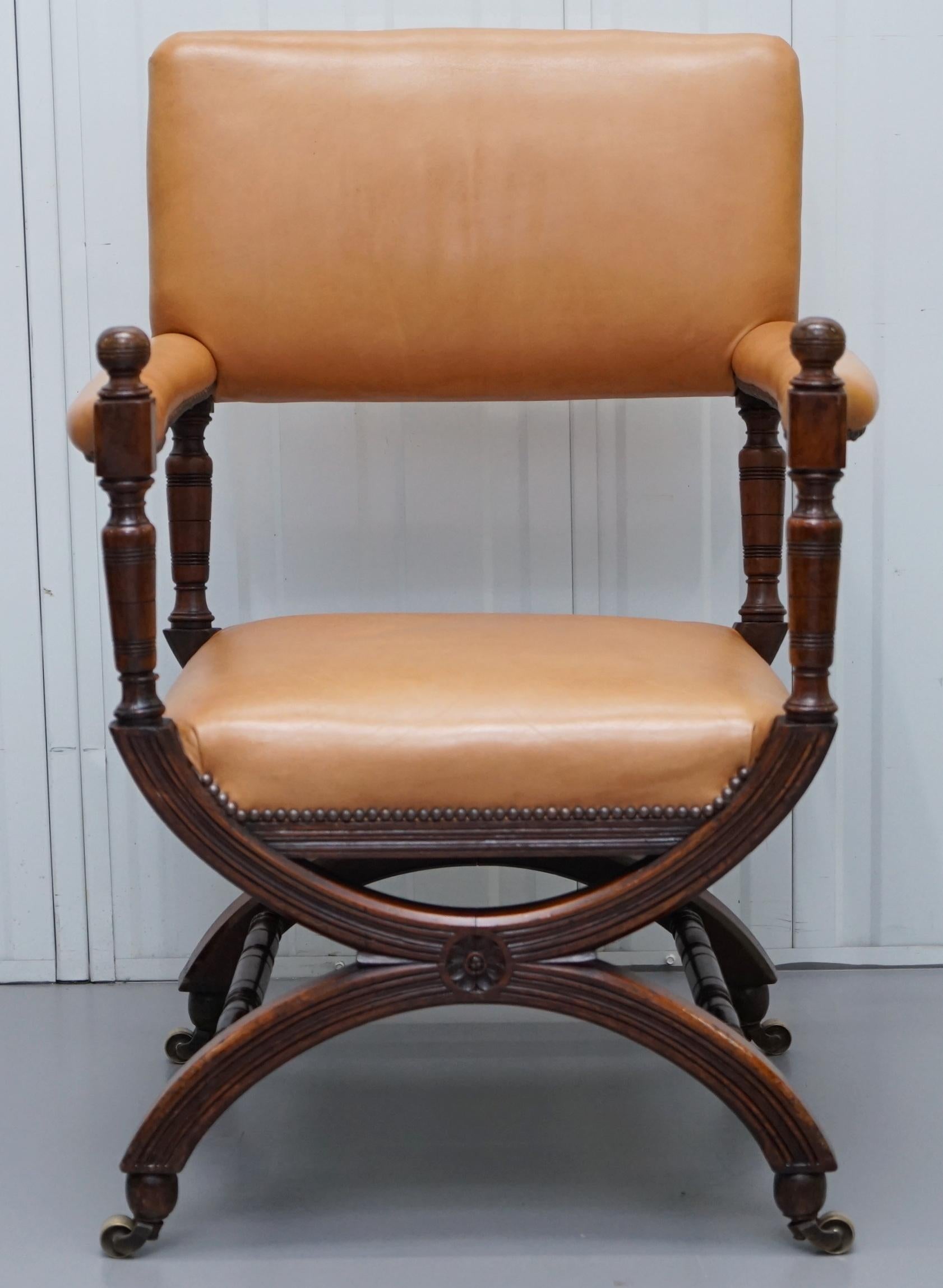 We are delighted to offer for sale this stunning mid Victorian Walnut frame open armchair with tan brown leather upholstery and brass castors

A very good looking decorative and comfortable armchair, the timber is hand carved and has a glorious