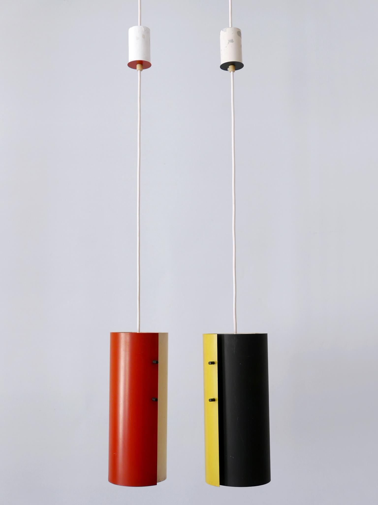 Elegant and highly decorative Mid-Century Modern bi-color metal pendant lamps or hanging lights. Designed & manufactured probably in Germany, 1960s.

Executed in white, yellow, black and red painted metal sheet and brass, each pendant lamp needs 1 x