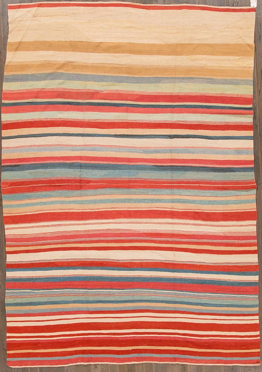 21st Century modern Turkish Kilim rug. This piece has a bright, multicolored striped field with light texturing. Measures: 7.09x11.