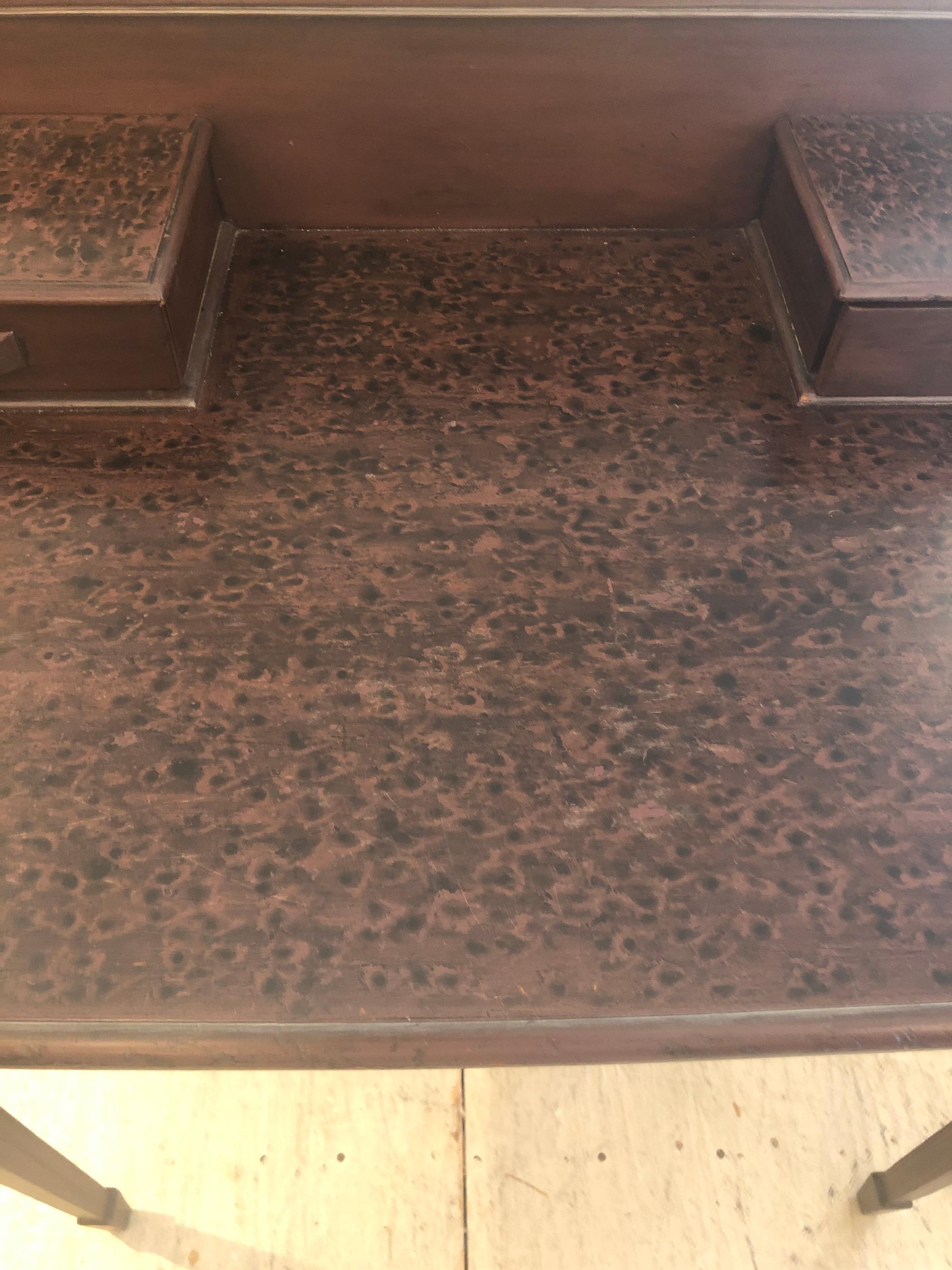 A lovely antique mahogany writing desk having a hand faux painted finish by well known Nantucket artist Willa Embry. Three drawers under the writing surface and two small drawers on the backsplash.
30 