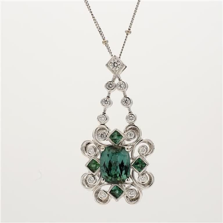 RareGemWorld's intriguing tourmaline pendant. Mounted in a beautiful 14K White Gold setting with natural cushion cut green tourmaline. The tourmaline is surrounded by natural small round natural white diamond melee. This pendant is guaranteed to