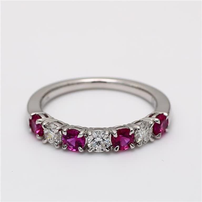RareGemWorld's classic ruby band. Mounted in a beautiful 14K White Gold setting with a natural round cut red ruby's complimented by natural round white diamond melee. This band is guaranteed to impress and enhance your personal collection!

Total