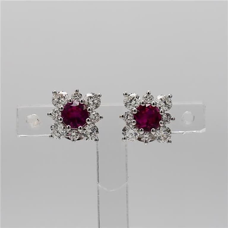 RareGemWorld's classic ruby earrings. Mounted in a beautiful 14K White Gold setting with natural round cut red ruby's. The ruby's are surrounded by round natural white diamond melee in a beautiful flower shape. These earrings are guaranteed to