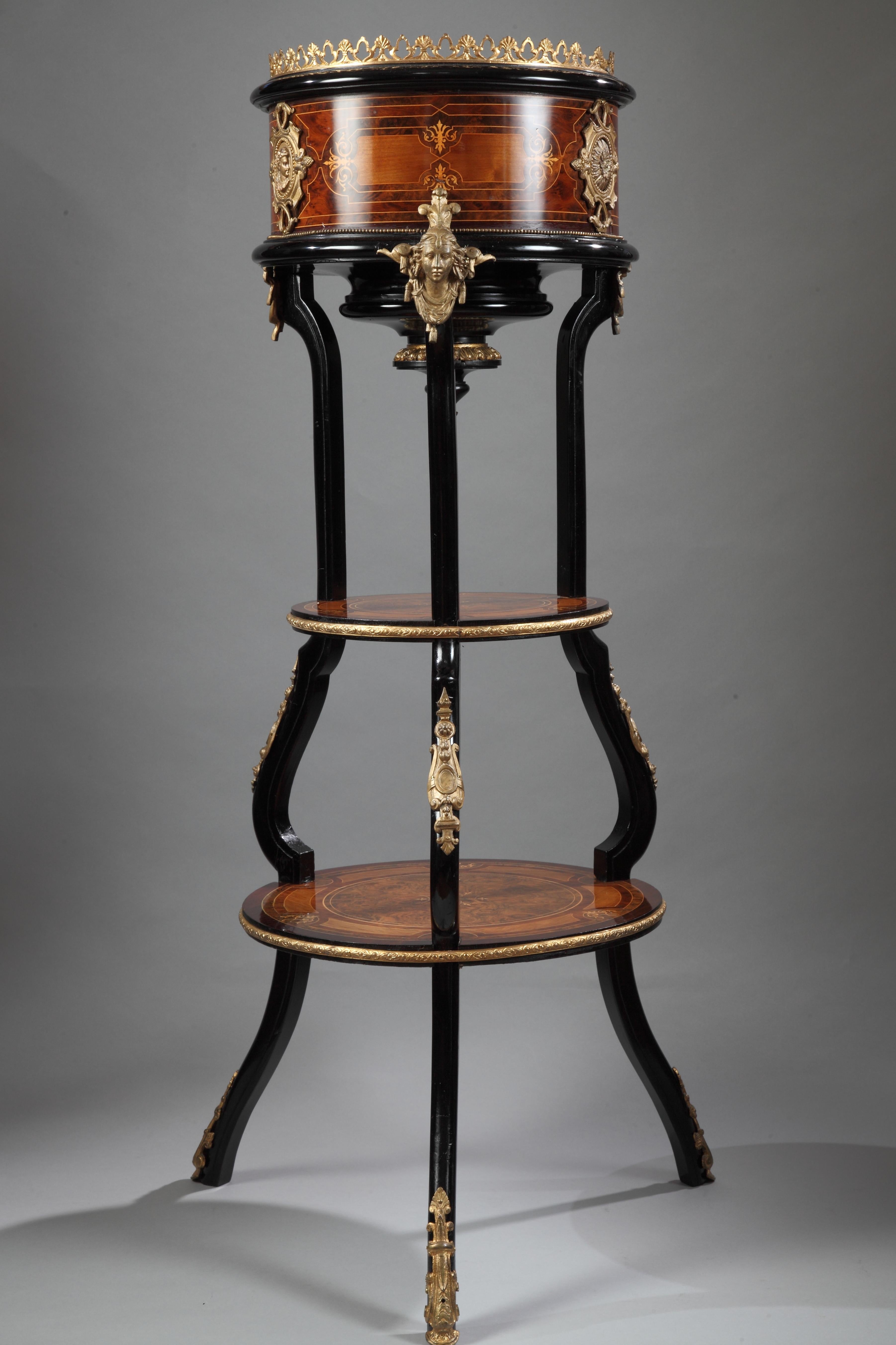 Circular plant pot with a double tray united by a black tripod attributed to C-G Diehl. Charming wood marquetry. A beautiful gilded bronze adornment complete this piece.

Arriving in Paris in circa 1840 Charles-Guillaume Diehl (1811-1885) founded