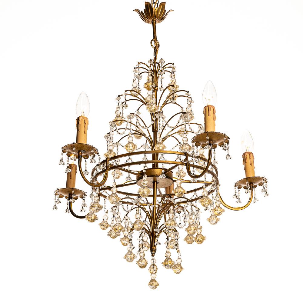 This old Italian chandelier has wonderful glass Pendants with gold coloring. Some pendants have been damaged on the rims surrounding the balls, but for me, that doesn't take away its beauty. It holds five E14 bulbs on the branches. We have put on