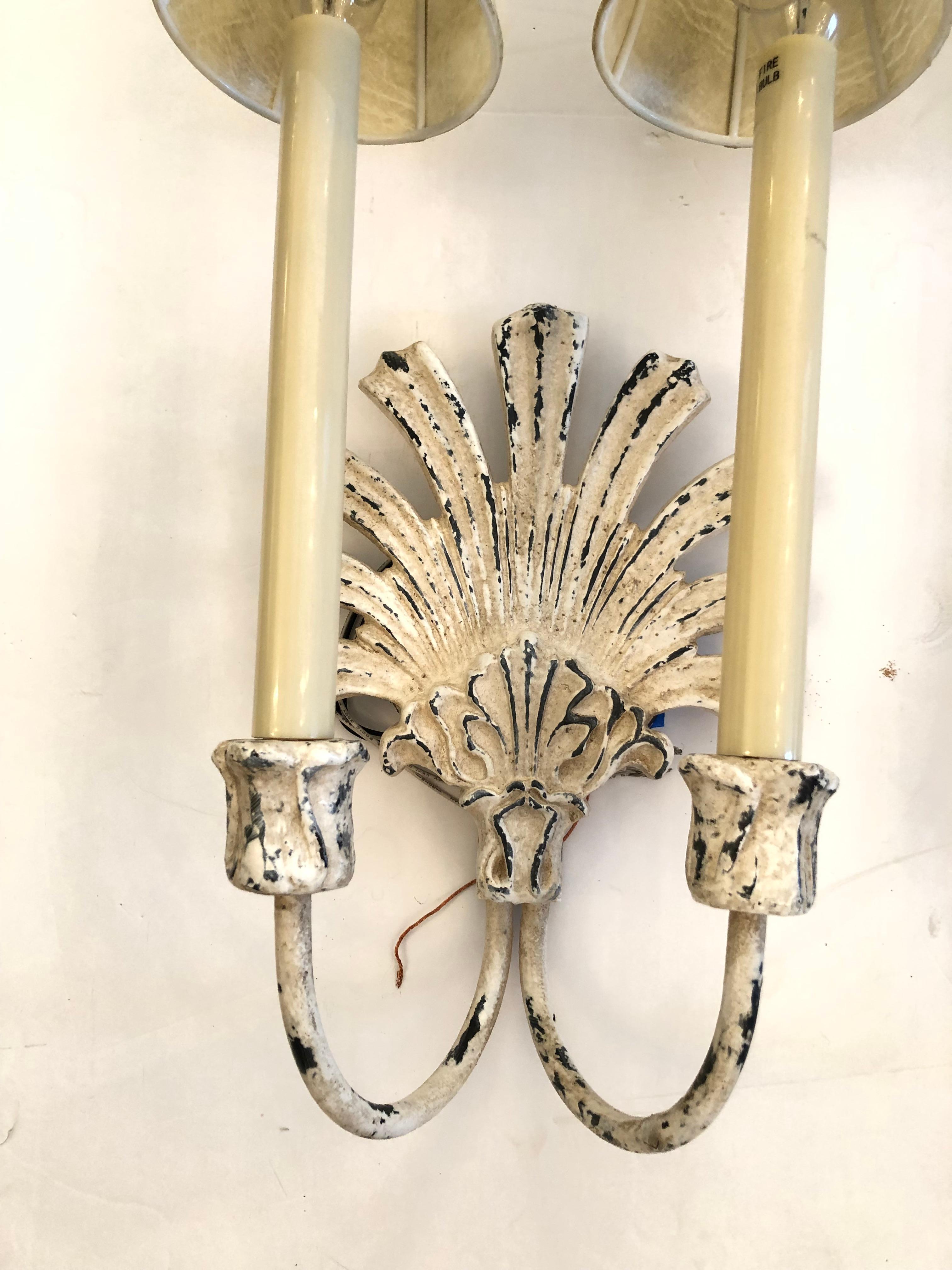 Pair of stylish off white painted iron sconces having zinc color underneath and a handsome distressed patina. Each sconce has two arms and custom shades.