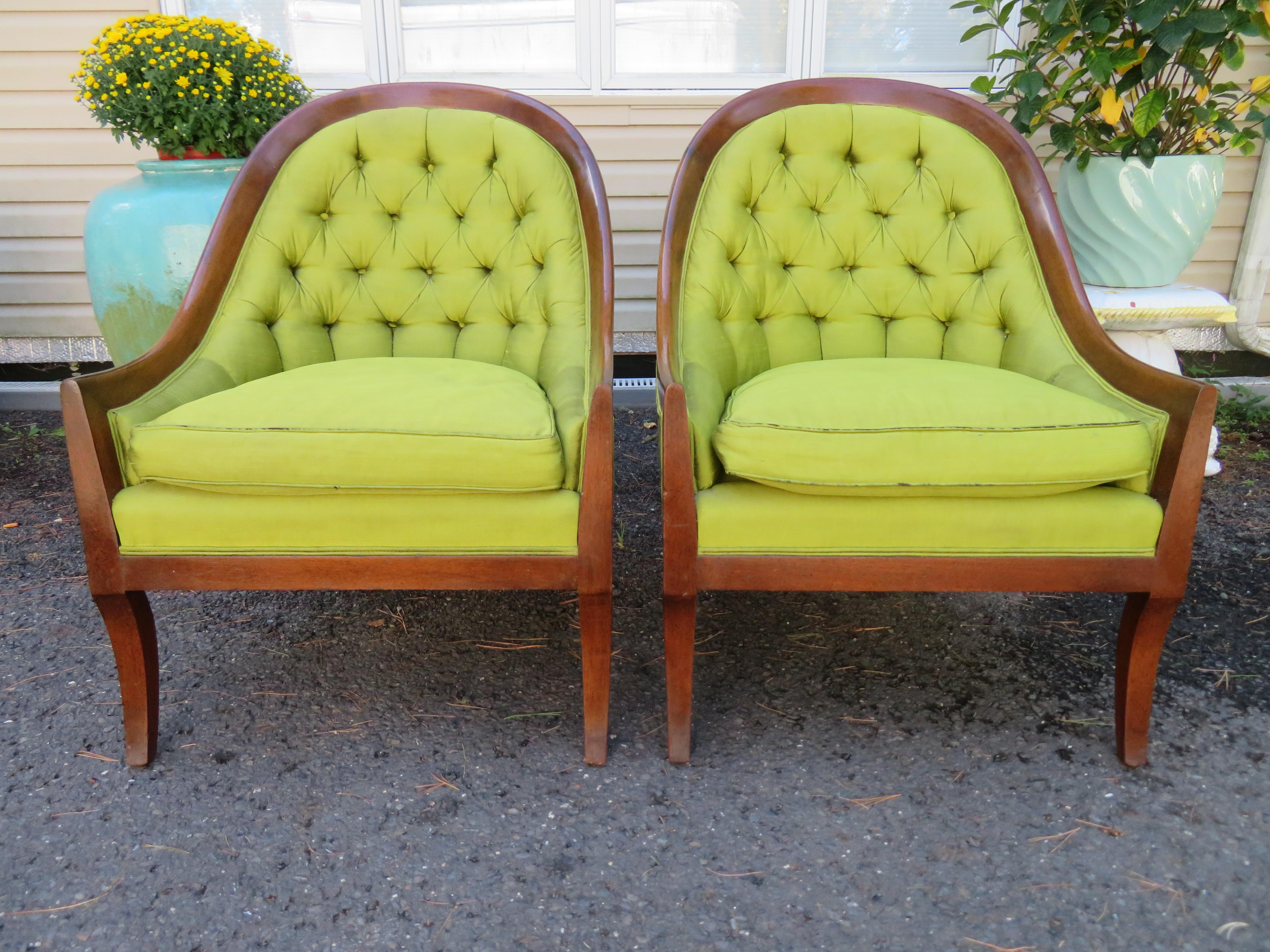 Lovely pair of Mid-century spoon-back chairs. We love the intentionally distressed fruitwood frame with the tufted back. The upholstery is worn and frayed around the edges and will need to be reupholstered. They measure 35.5