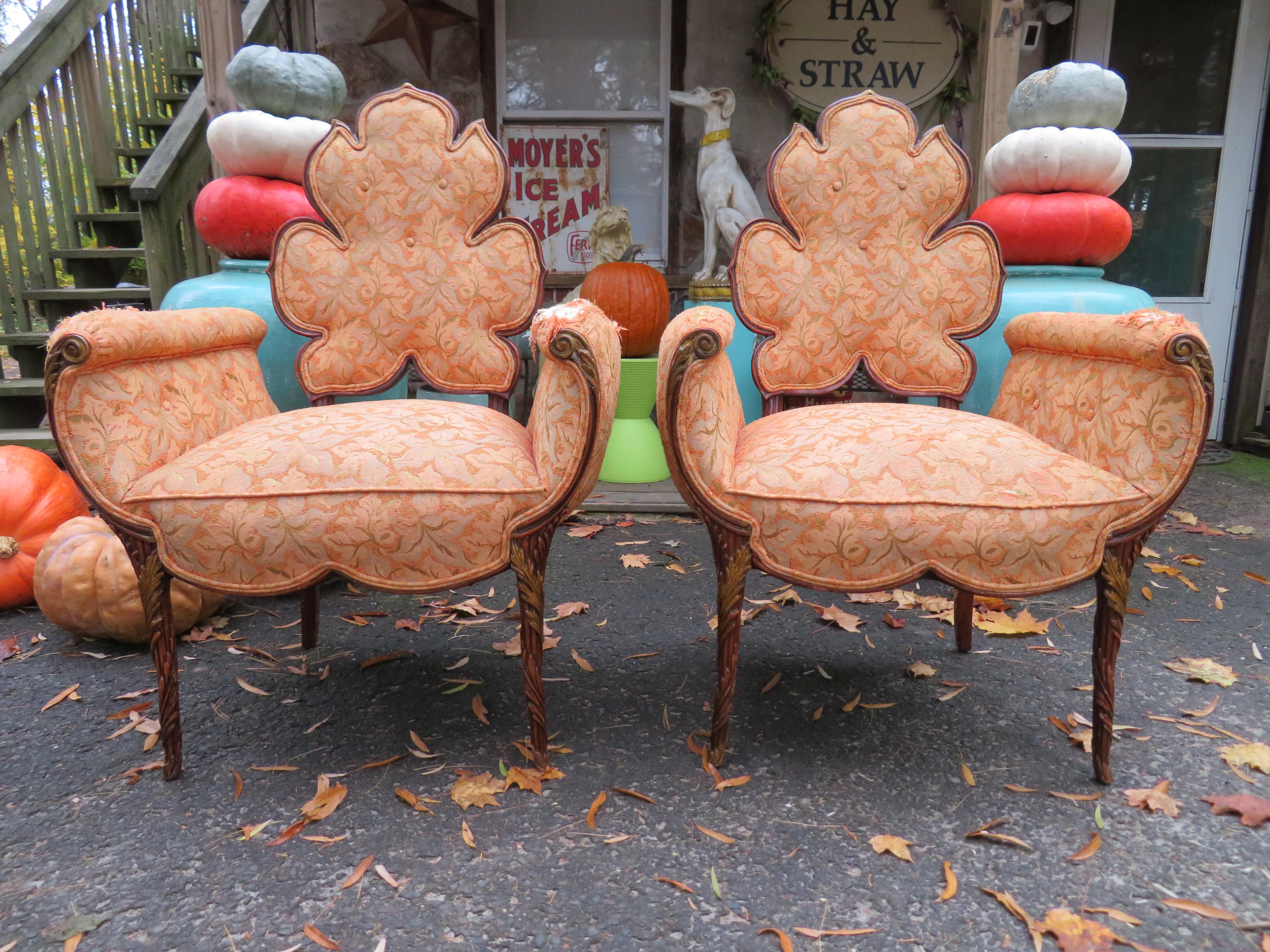 A spectacular pair of Grosfeld House chairs featuring a flower shaped backrest, channeled arms and an intricate carved wooden frame. A rare and completely stunning pair of chairs from the prestigious design house, 1940s. The original fabric does