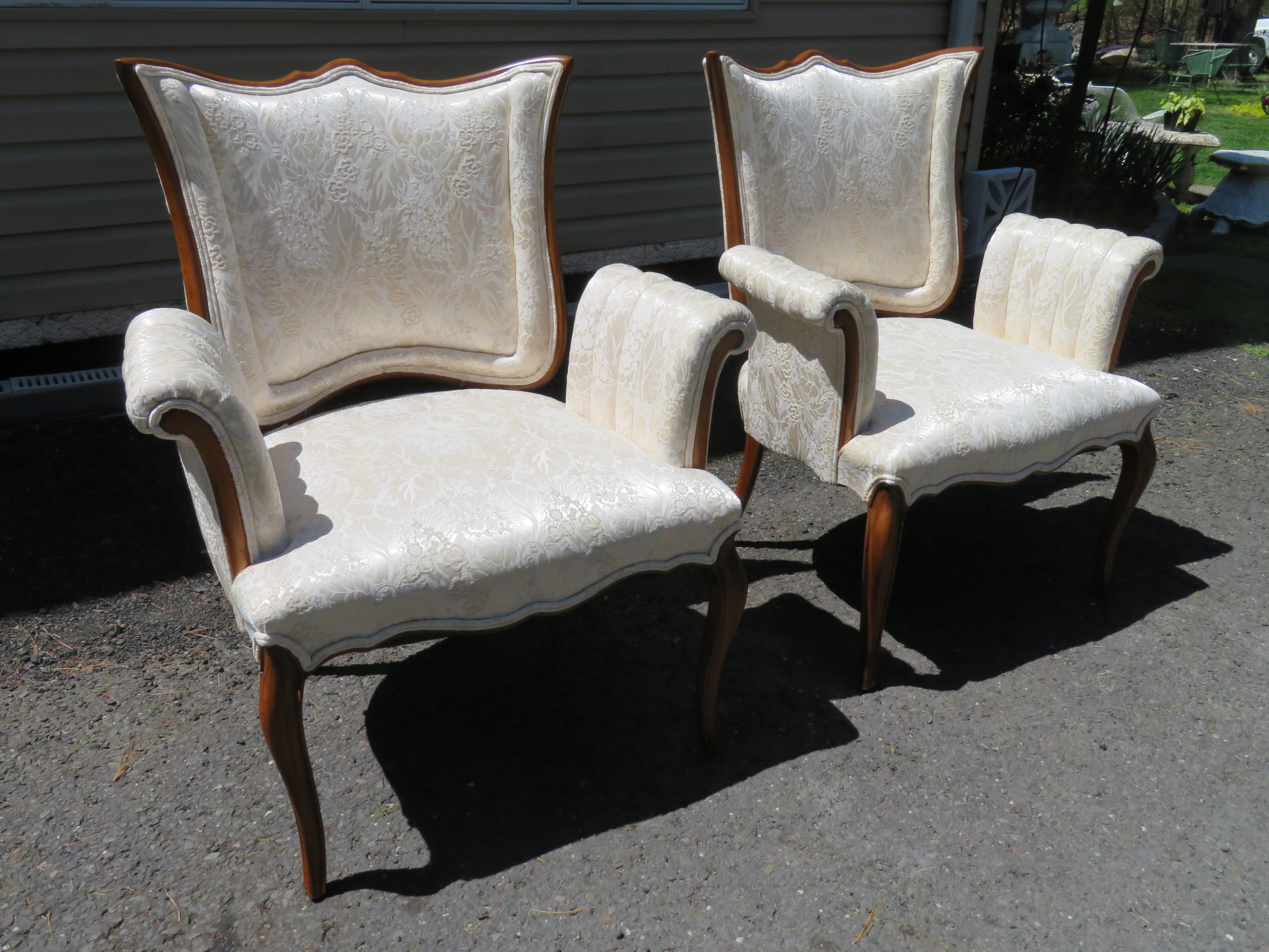 Lovely pair of Hollywood Regency scroll arm lounge chairs with shield-shaped backs. These elegant chairs have all the quality and craftsmanship of other pieces we have made by Grosfeld House. They measure 36.5
