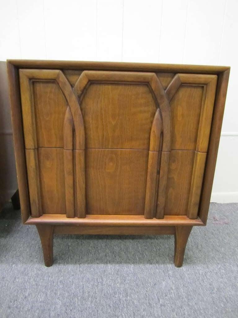 Lovely pair of American mid-century modern walnut night stands.  The well carved drawer fronts give these a classical feel.  You will love the quality and craftsmanship of these American beauties.