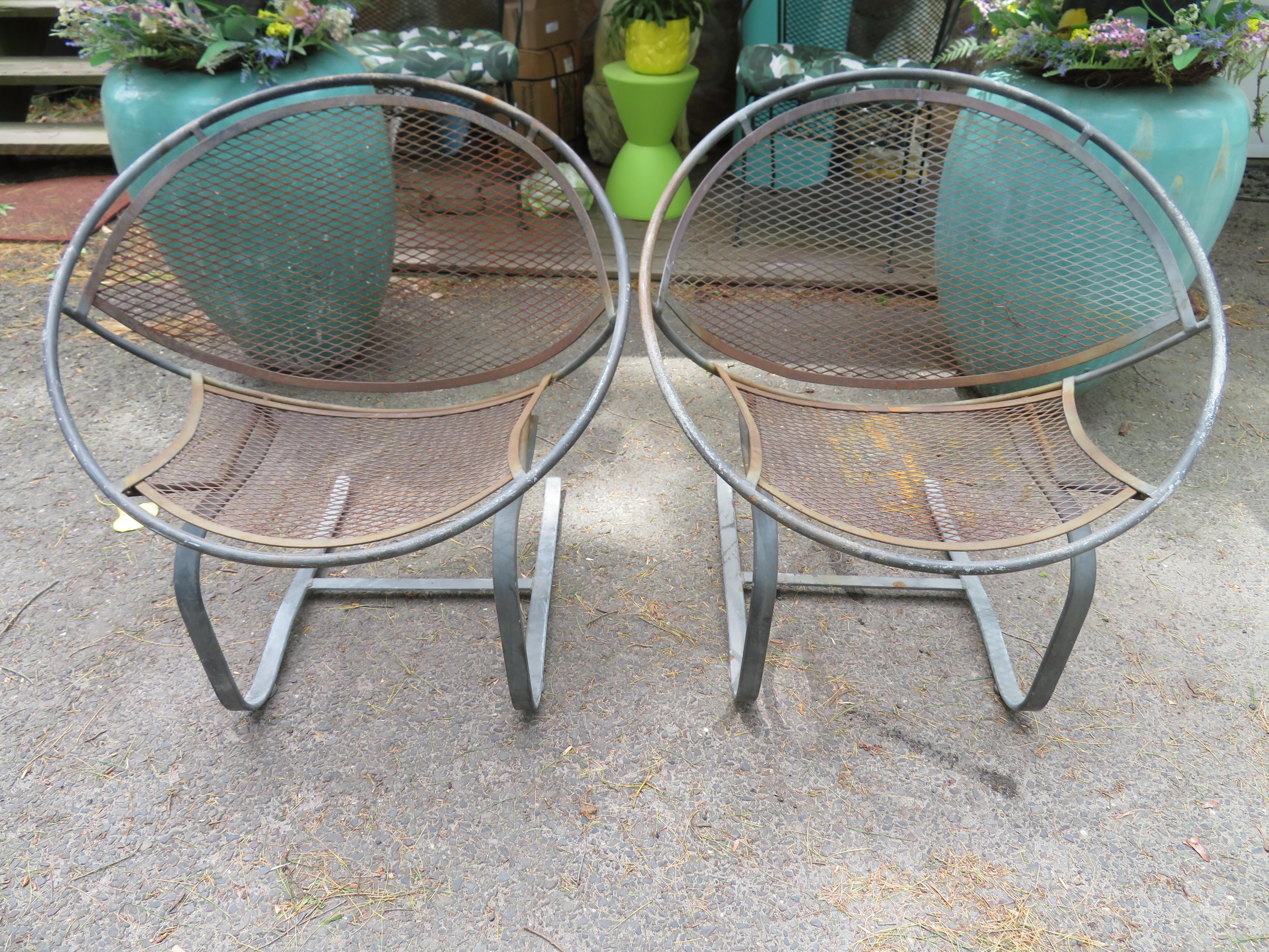 Lovely pair of springer radar chairs for Salterini designed by Maurizio Tempestini. Spring action, round saucer like frame, with mesh metal backing. These chairs measure 32