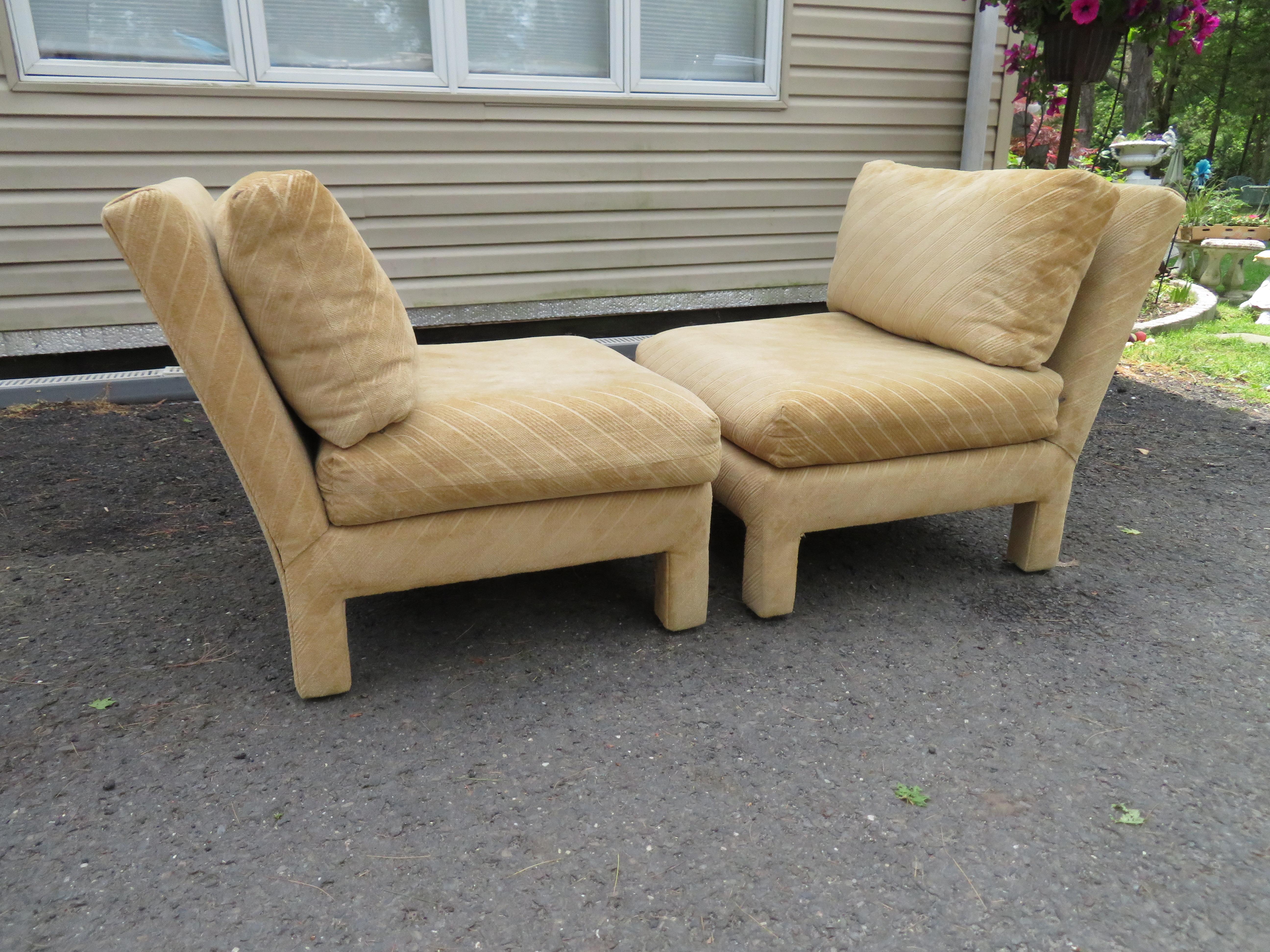Lovely pair of Milo Baughman style upholstered Parson slipper chairs. These chairs retain their original tan striped cut velvet upholstery in usable condition. They measure 29