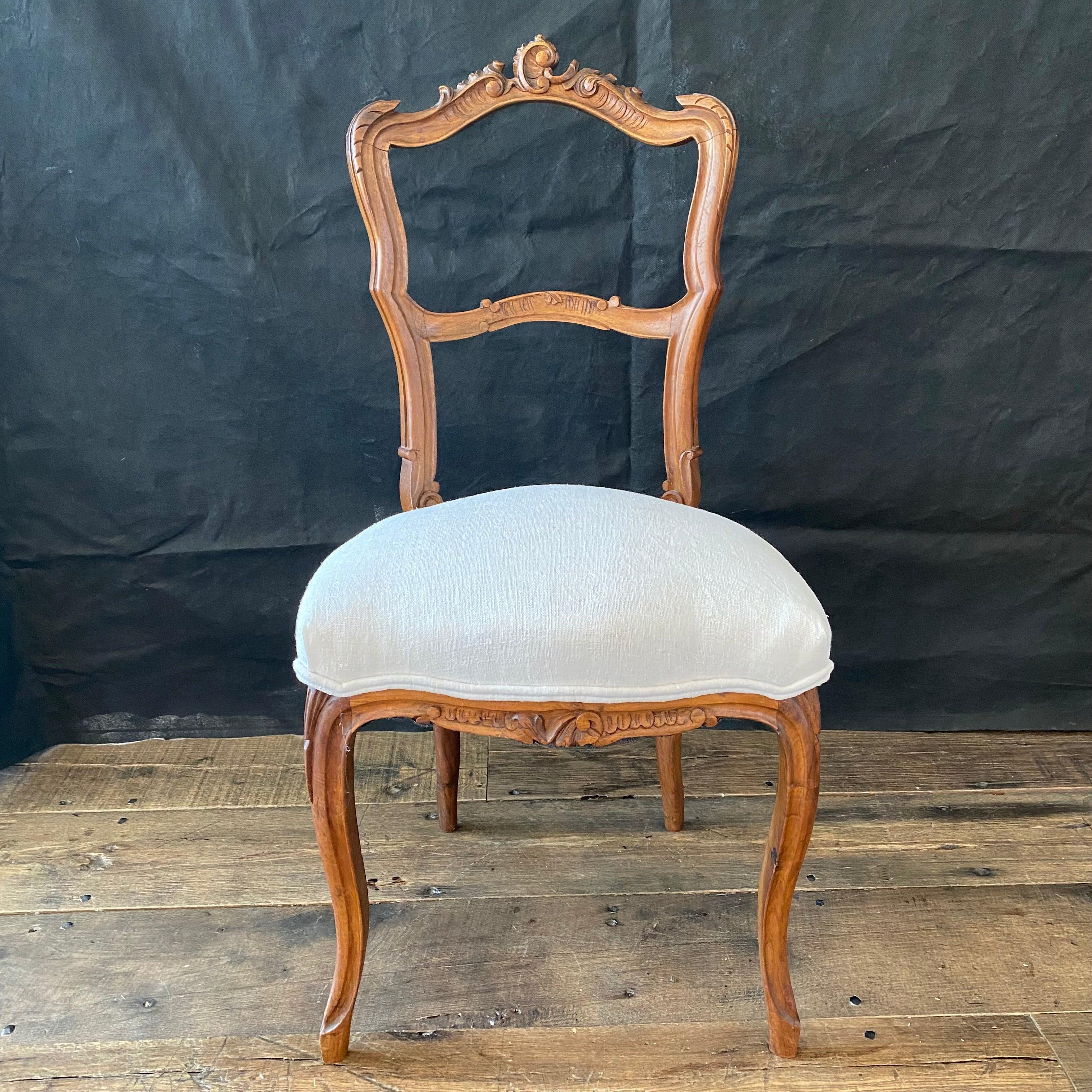 Really high quality pair of Louis XV side chairs bought outside Paris having beautiful hand carved walnut backs, aprons and cabriolet legs. All new neutral upholstery highlights the lovely detail of the chairs.

#4619.