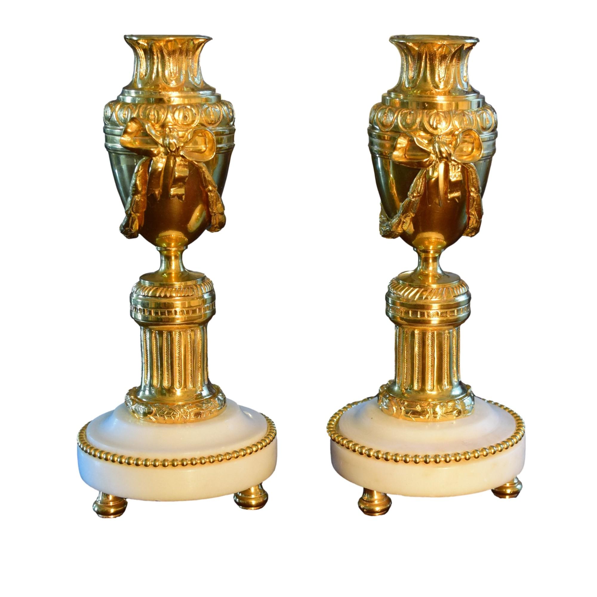 

A lovely Pair of Antique French Louis XVI Style Ormolu Cassolettes.

The two Cassolettes show a round white marble pedestal resting on spheres of gilt bronze and lined with acanthus leaves and bronze pearls.
The Body rises in the form of an