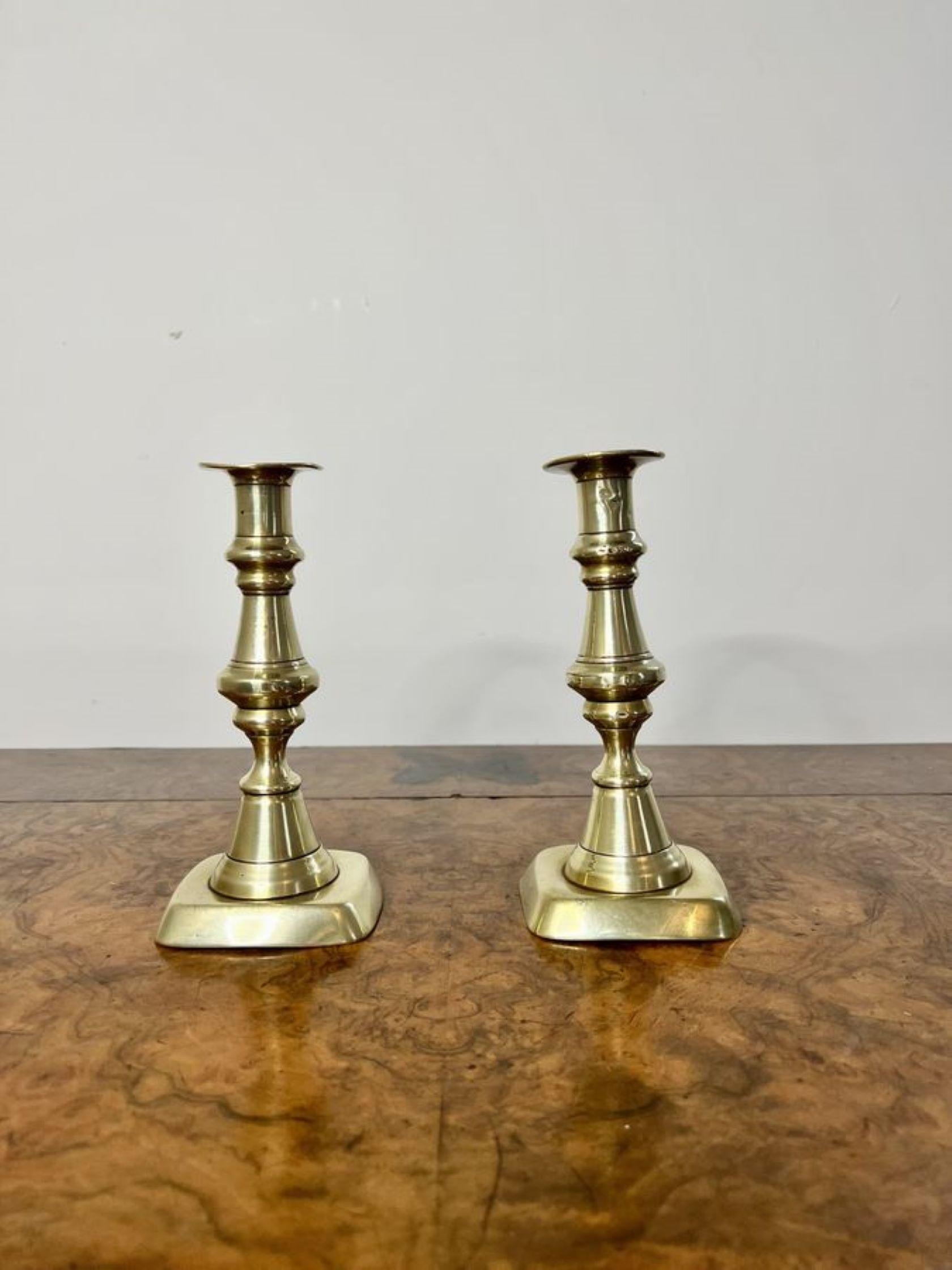 Lovely pair of antique Victorian brass candlesticks having a lovely pair of antique brass candlesticks with turned shaped columns standing on square bases.

D. 1860