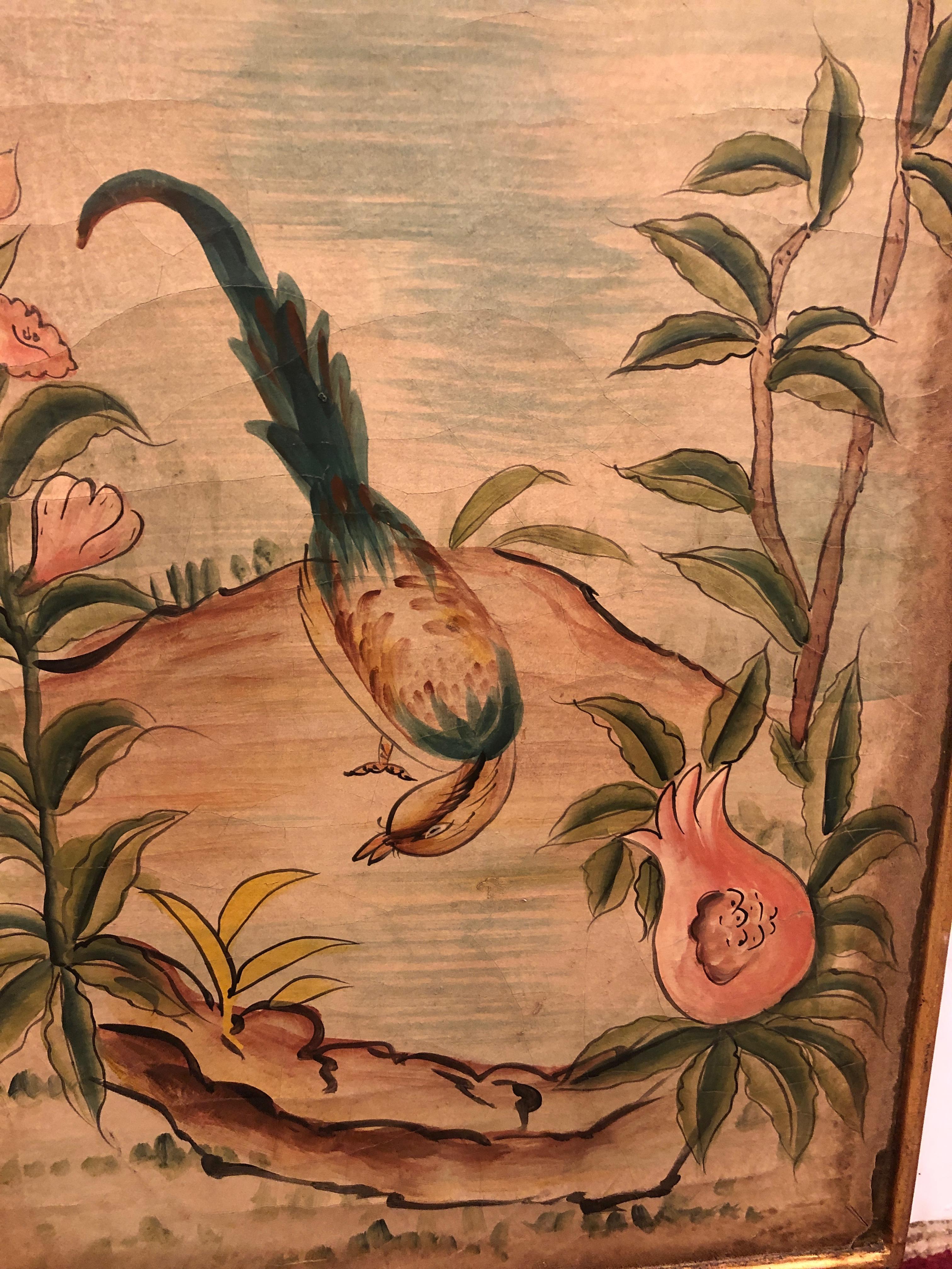 An elegant aged pair of Asian style rectangular hand painted panels having beige background with craquelure, lovely birds and foliage in muted shades of blue, salmon, and green. Simple gilded frame is fused with the panels.
