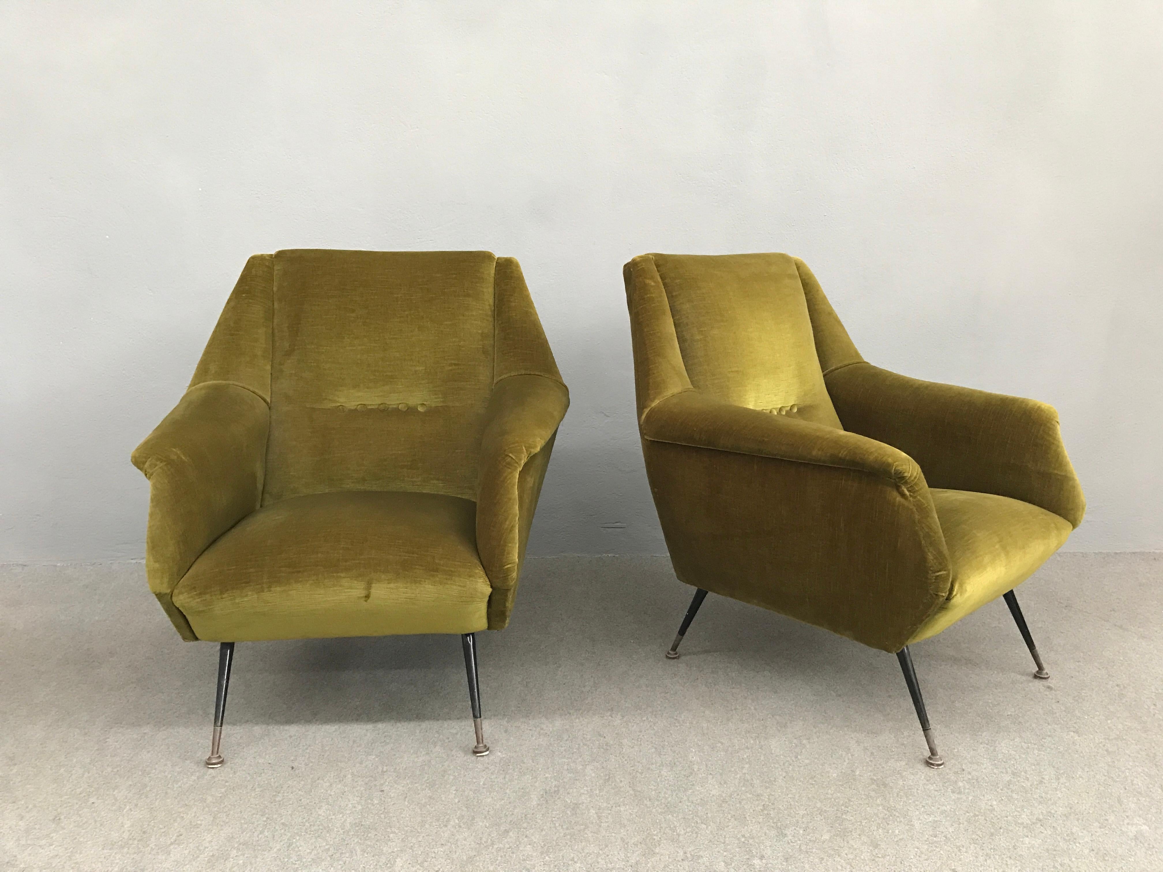 Pair of Italian armchairs with original green velvet upholstery, black laquered legs and brass sabot.