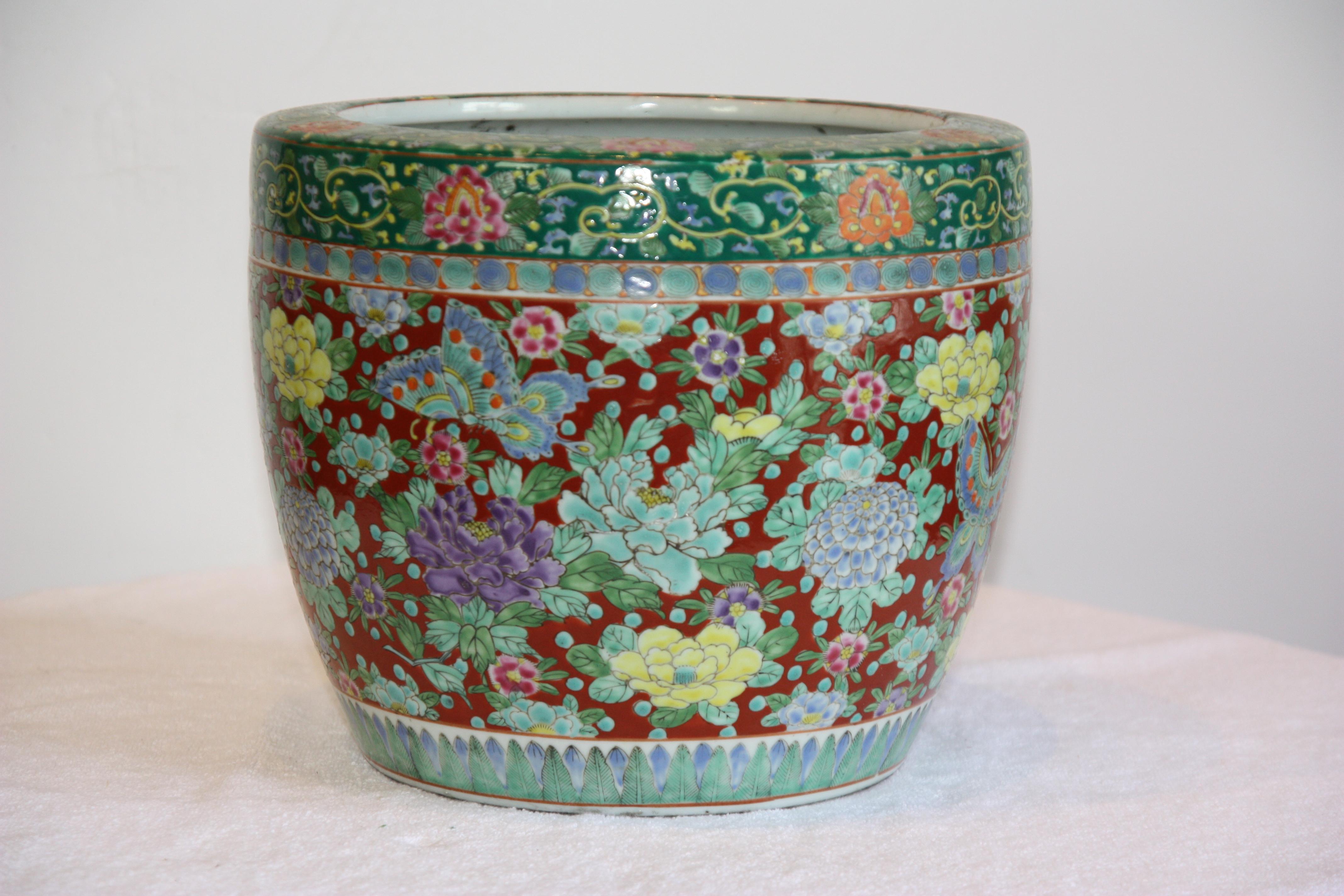 Gorgeous pair of late 19th century hand-painted, green and red jardinières with flowers adorning them.